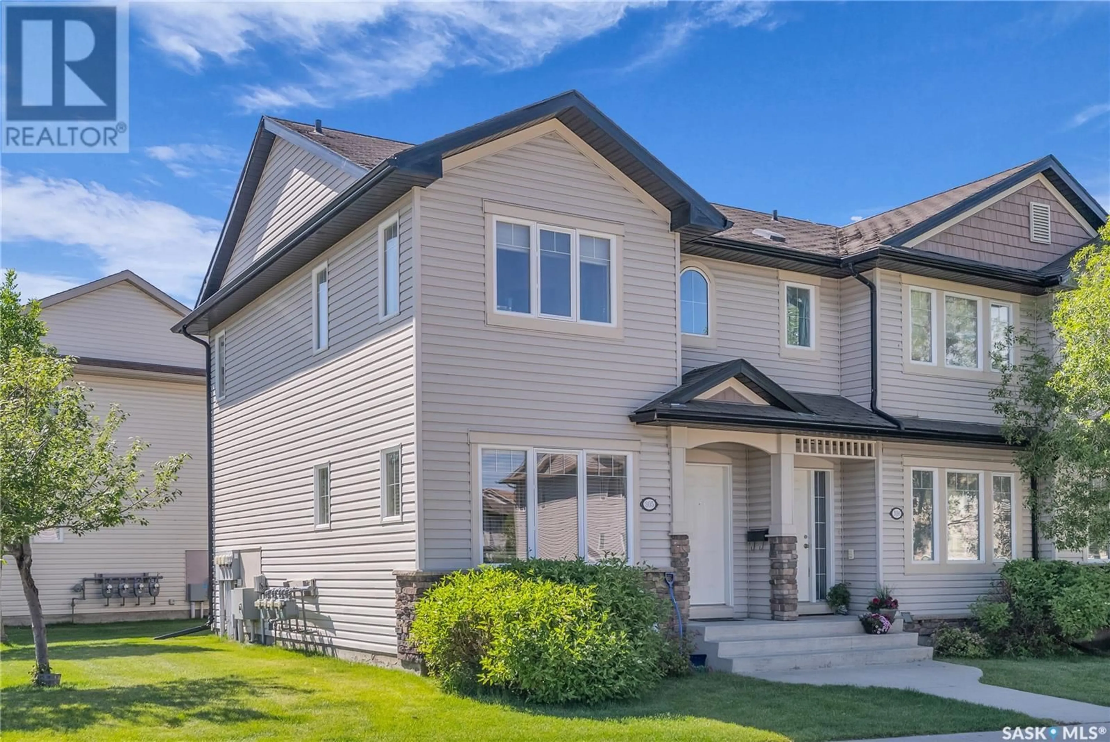 Home with vinyl exterior material, street for 303 - 305 SLIMMON PLACE, Saskatoon Saskatchewan S7V0A8