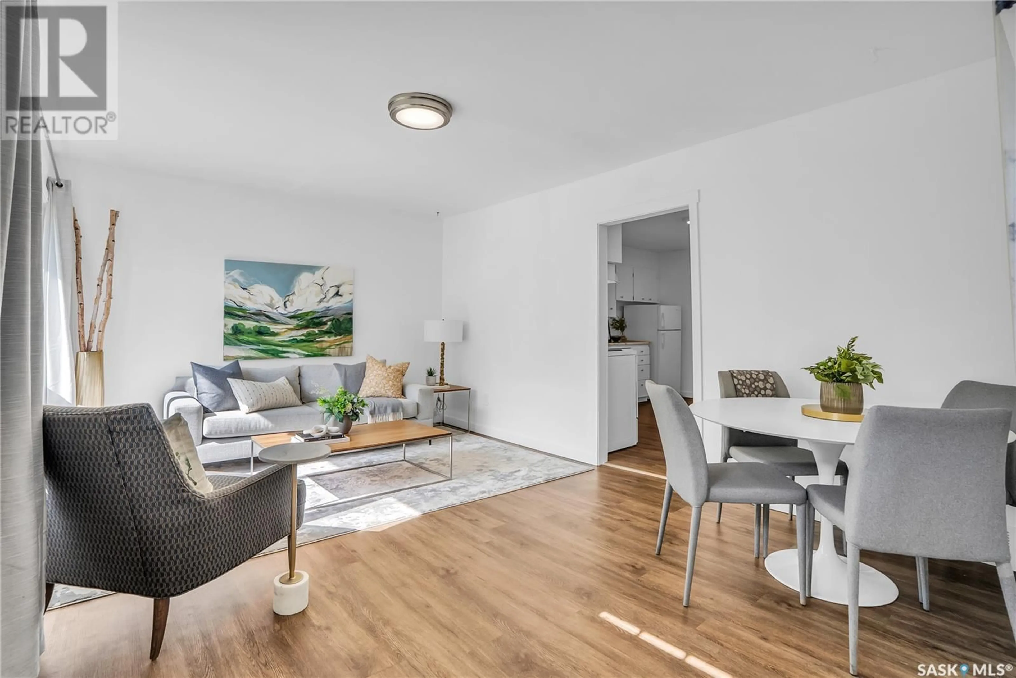 Living room with furniture, wood/laminate floor for 2535 KELVIN AVENUE, Saskatoon Saskatchewan S7J0T6