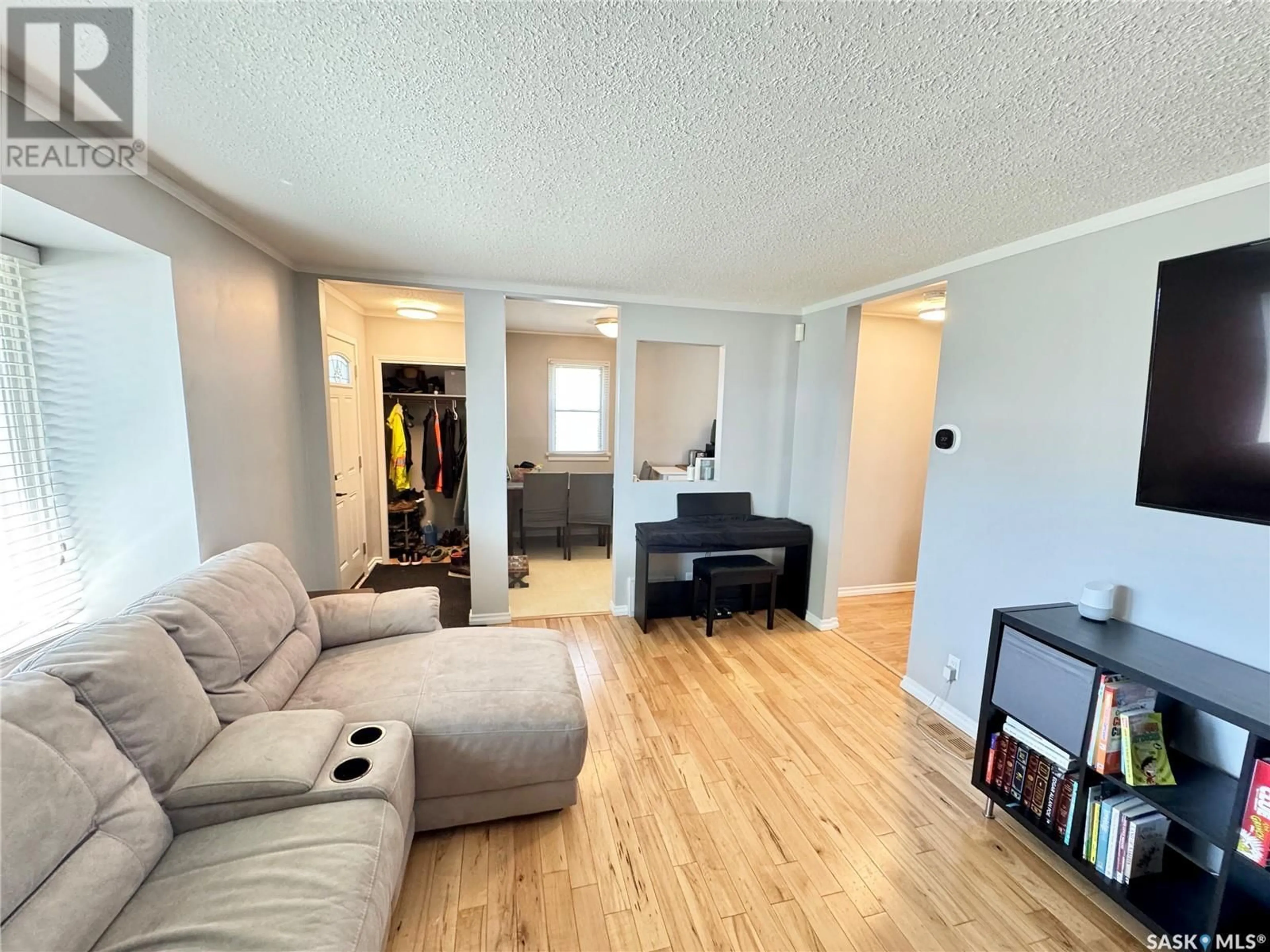 Living room with furniture, wood/laminate floor for 4 SUSSEX CRESCENT, Regina Saskatchewan S4T6A2