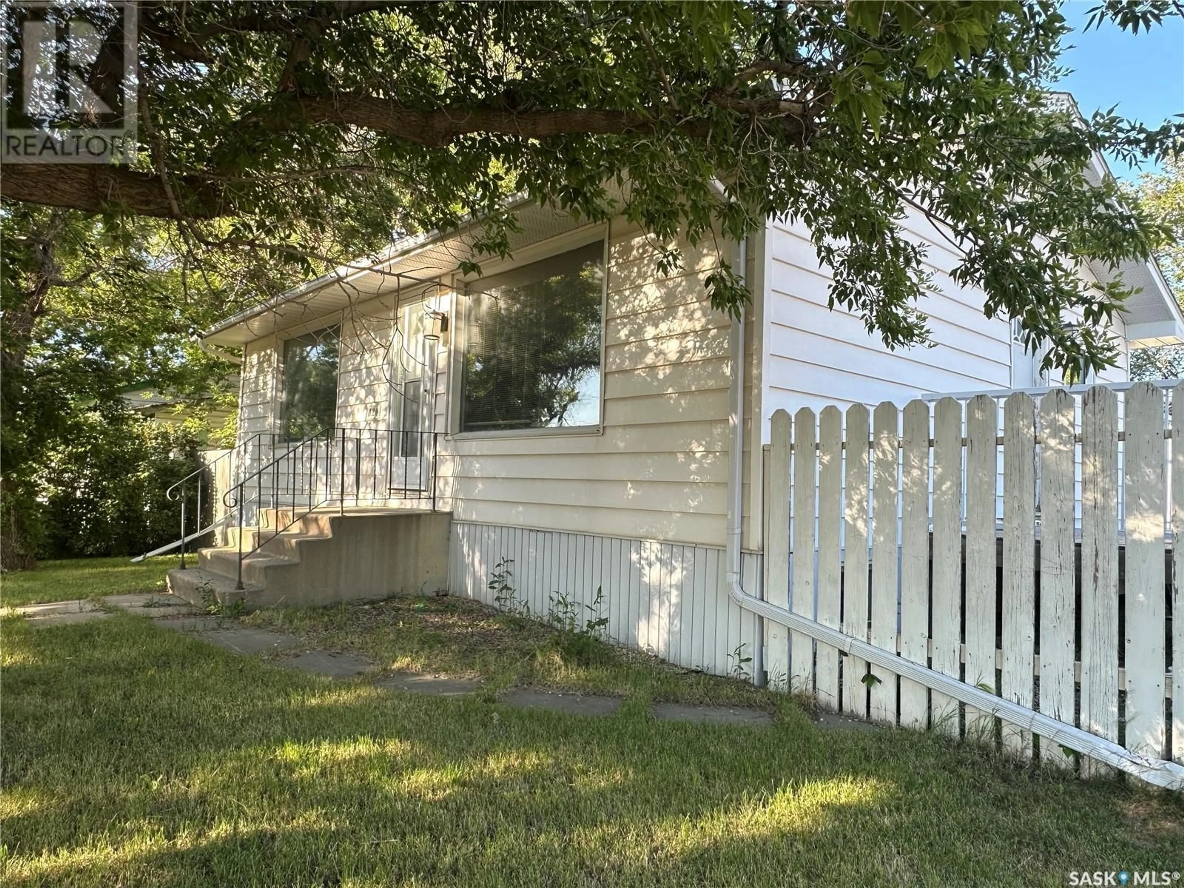 Home with vinyl exterior material, street for 320 GOVERNMENT ROAD, Weyburn Saskatchewan S4H2A8