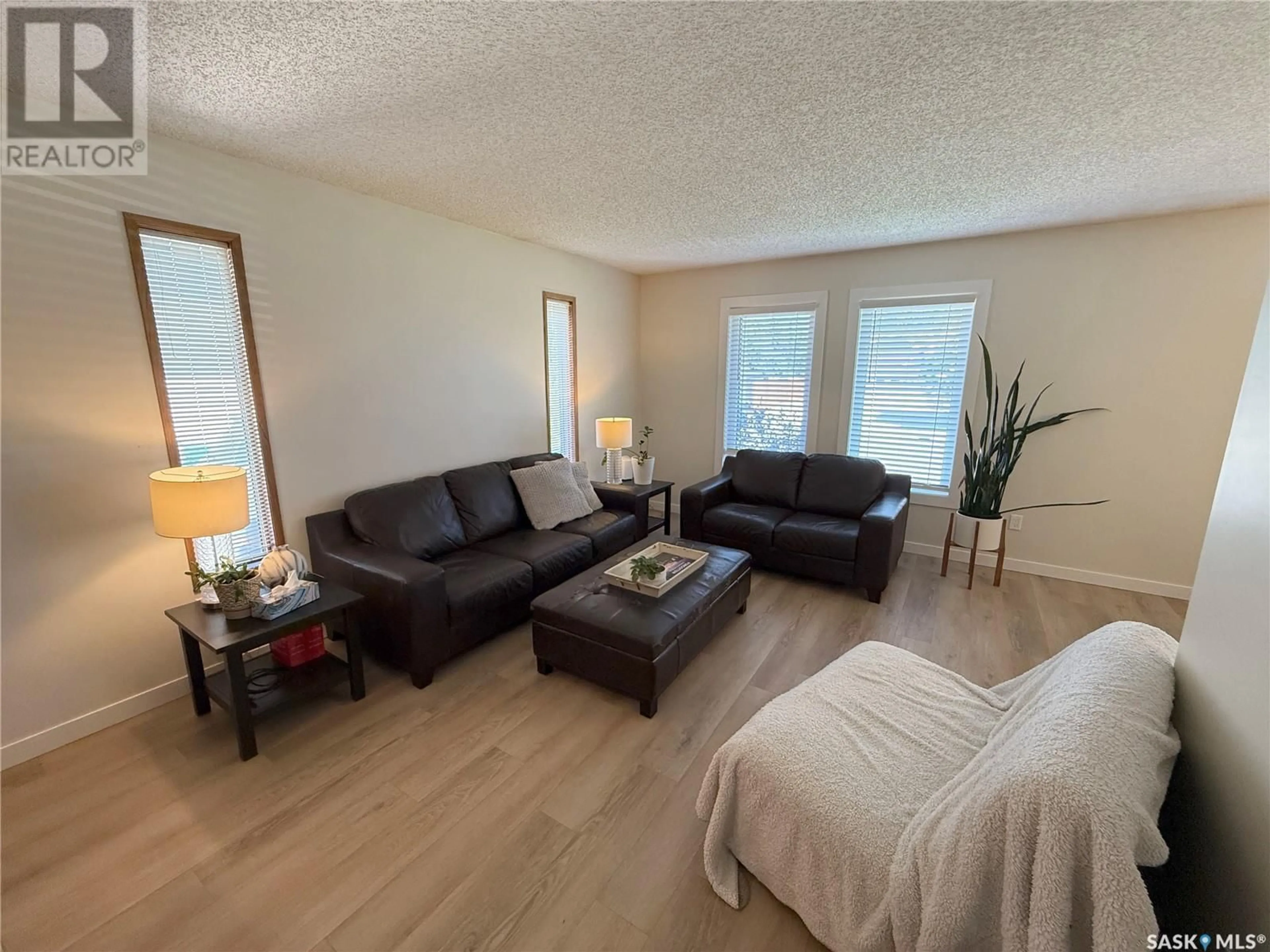 Living room with furniture, wood/laminate floor for 359 VERBEKE ROAD, Saskatoon Saskatchewan S7K6J2