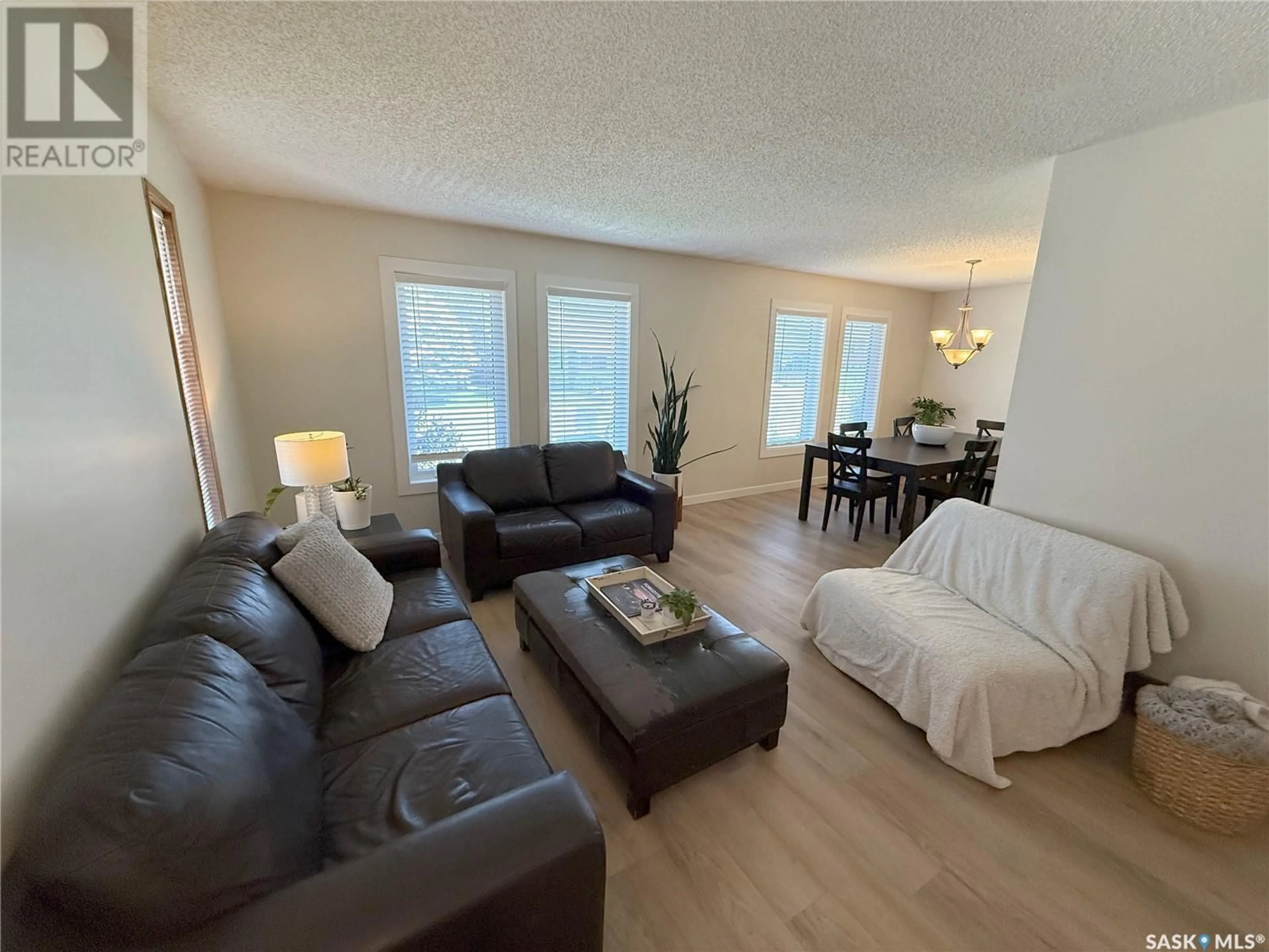 Living room with furniture, wood/laminate floor for 359 VERBEKE ROAD, Saskatoon Saskatchewan S7K6J2