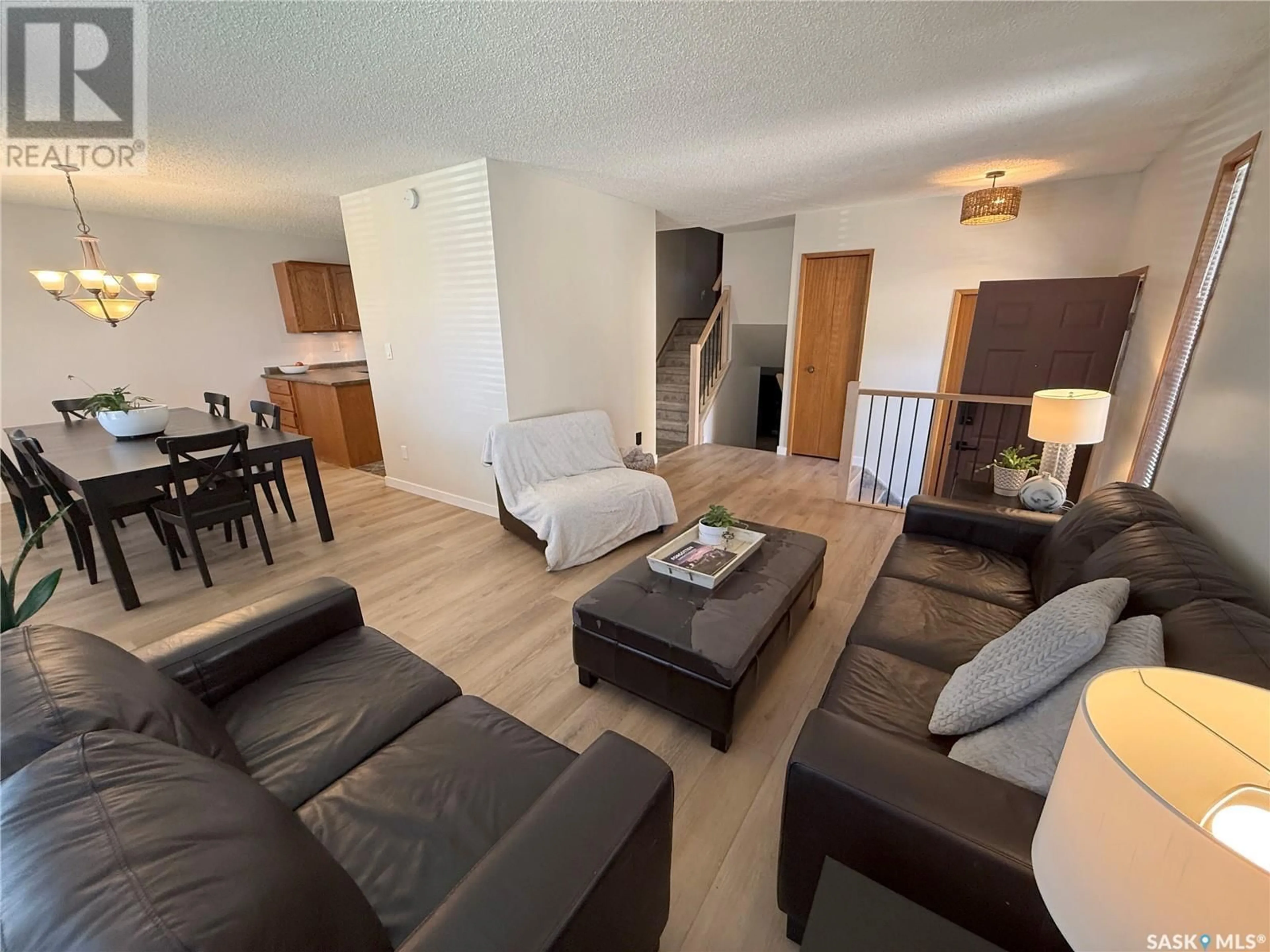 Living room with furniture, wood/laminate floor for 359 VERBEKE ROAD, Saskatoon Saskatchewan S7K6J2