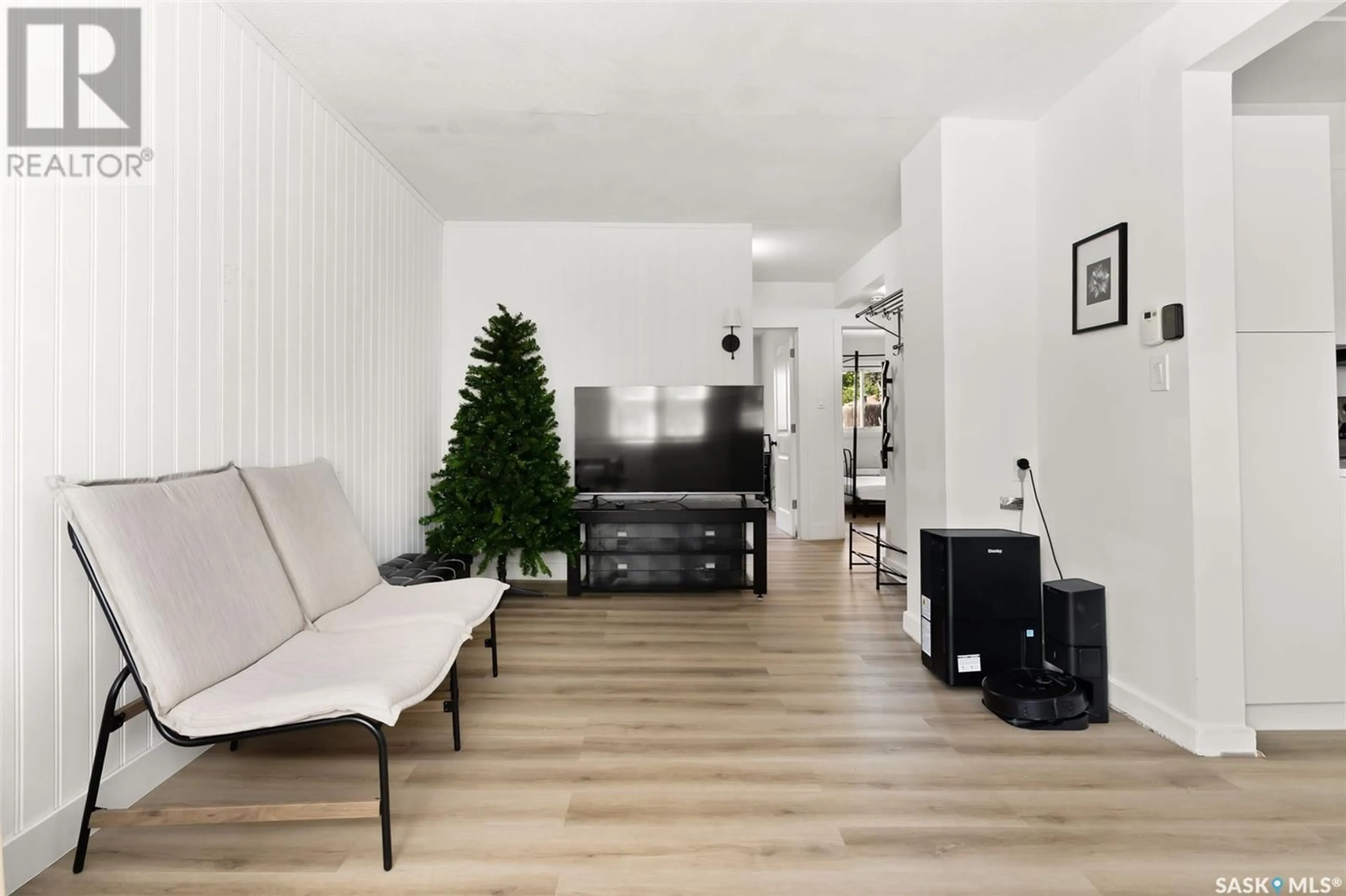 Living room with furniture, wood/laminate floor for 2434 MCDONALD STREET, Regina Saskatchewan S4N2Z3