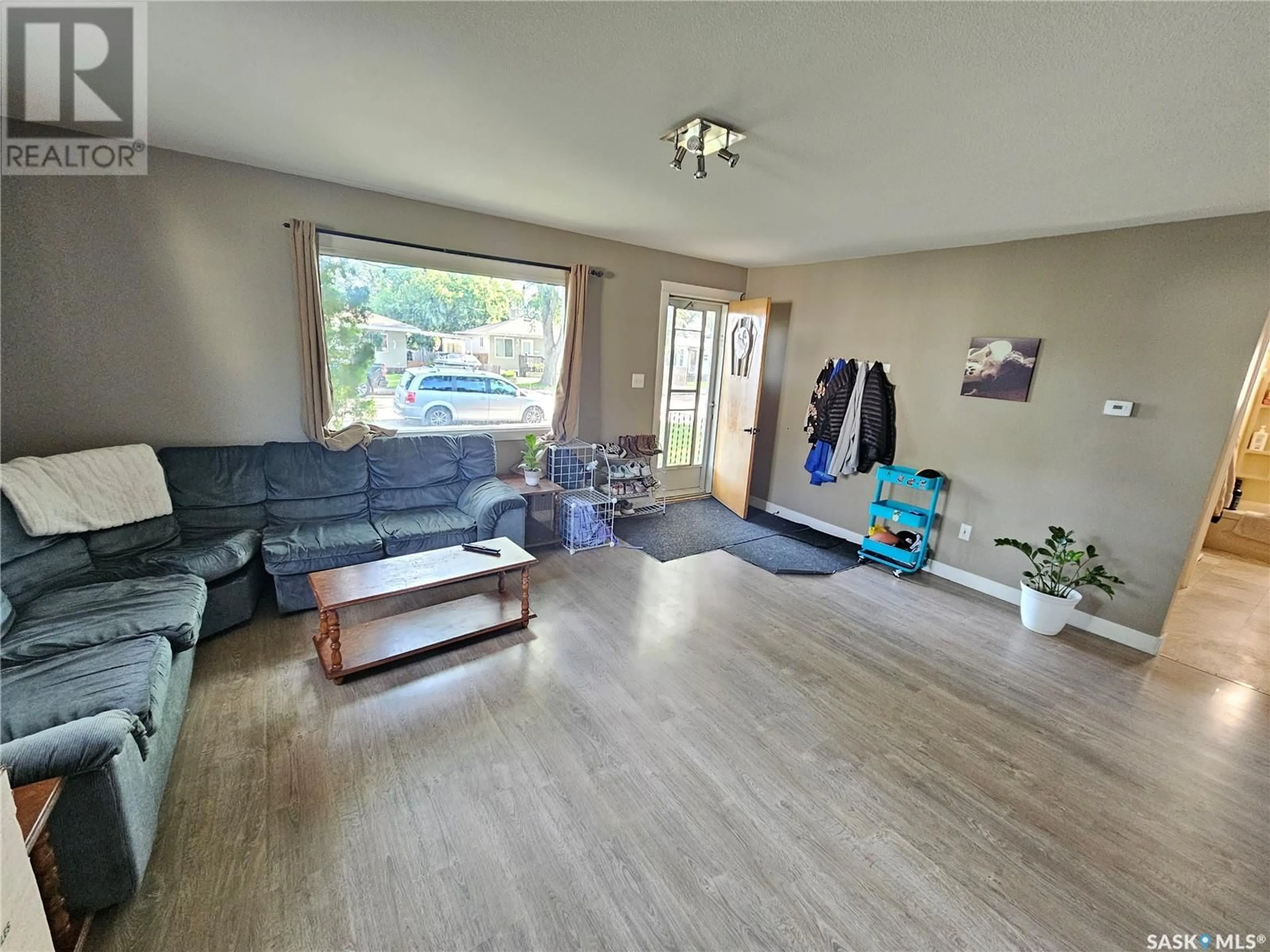 Living room with furniture, wood/laminate floor for 823 DUFFIELD STREET, Moose Jaw Saskatchewan S6H5J6