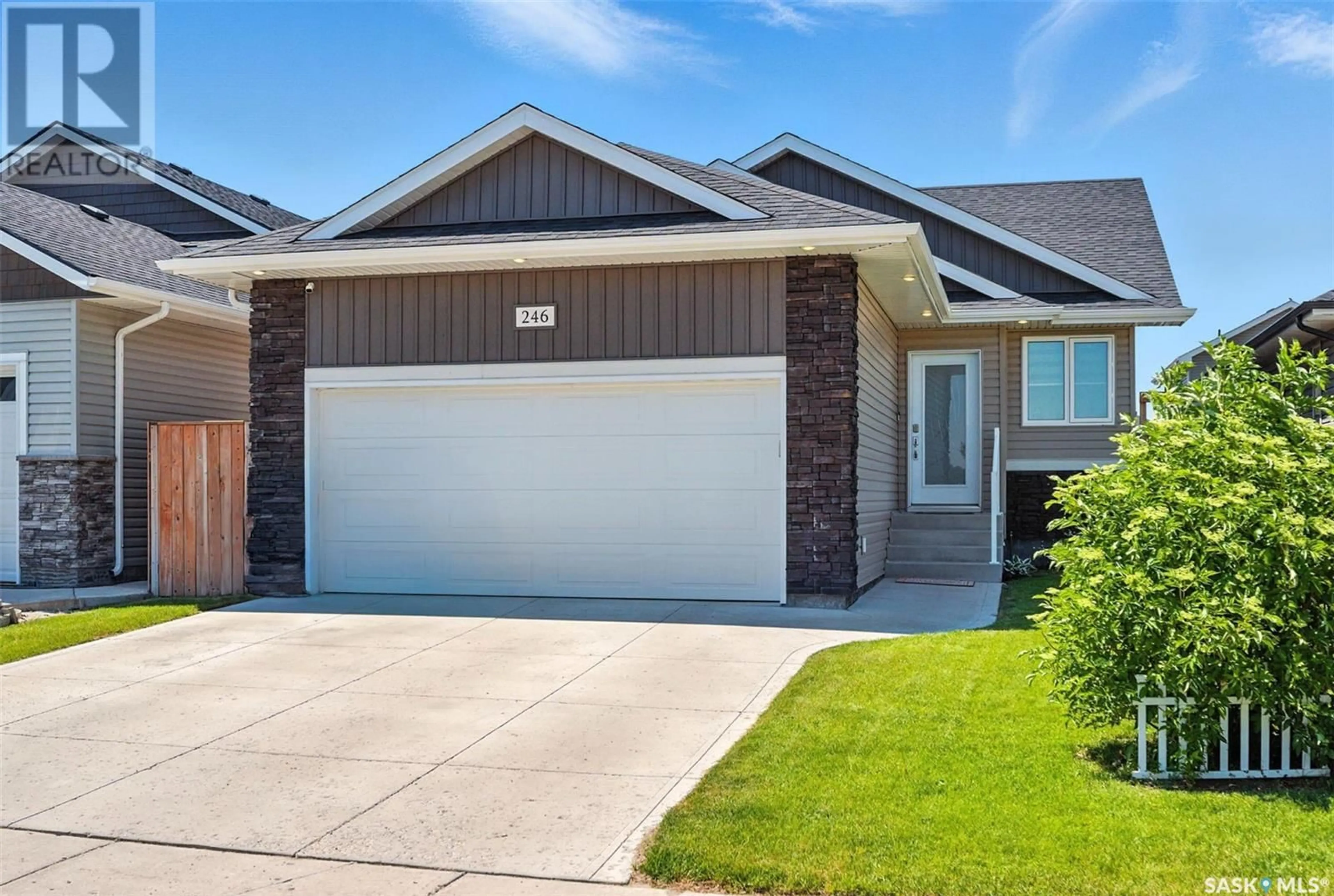 Home with vinyl exterior material, street for 246 HASSARD CLOSE, Saskatoon Saskatchewan S7L4Z7