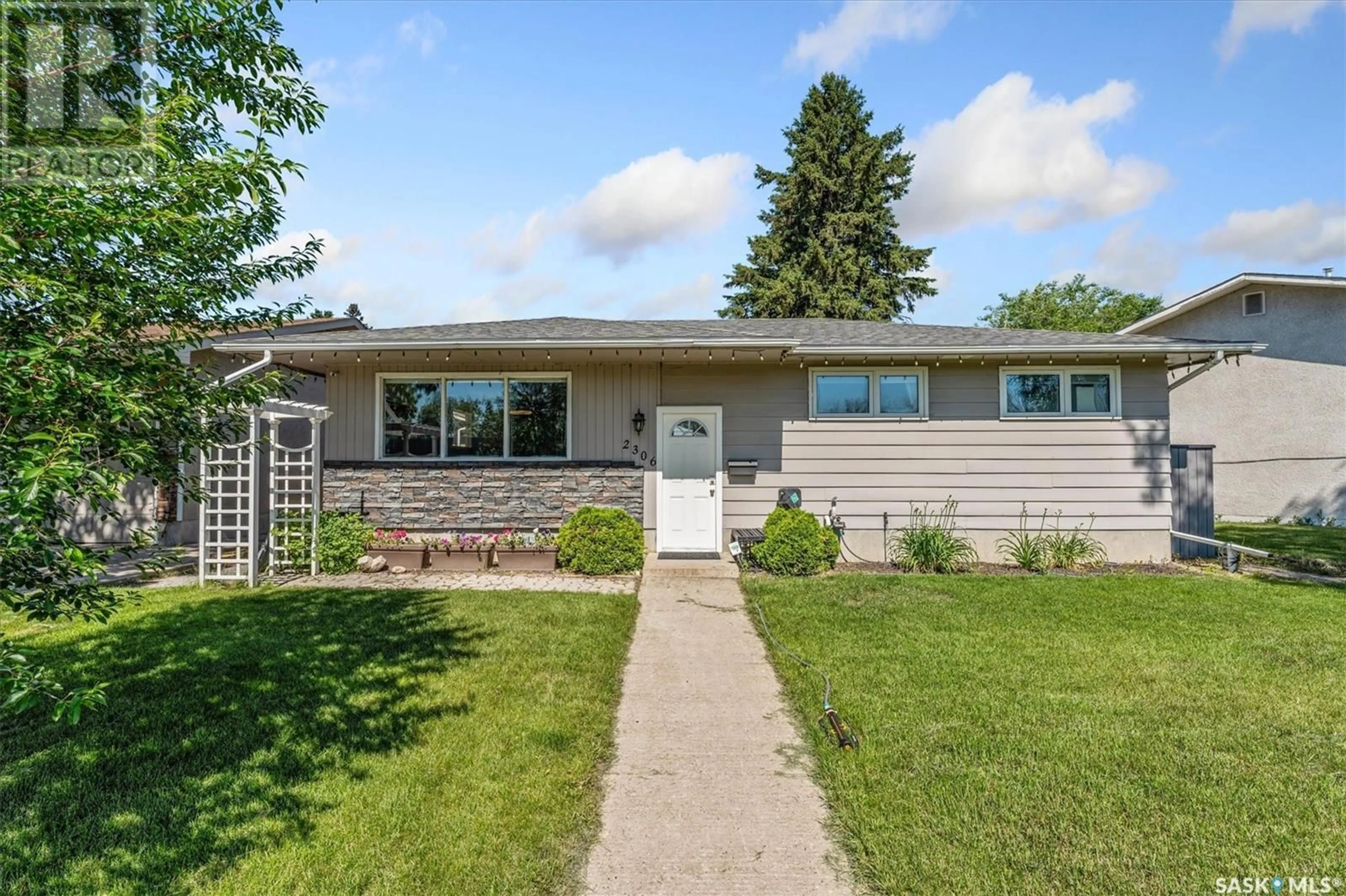 Home with vinyl exterior material, street for 2306 EASTHILL, Saskatoon Saskatchewan S7J3E5