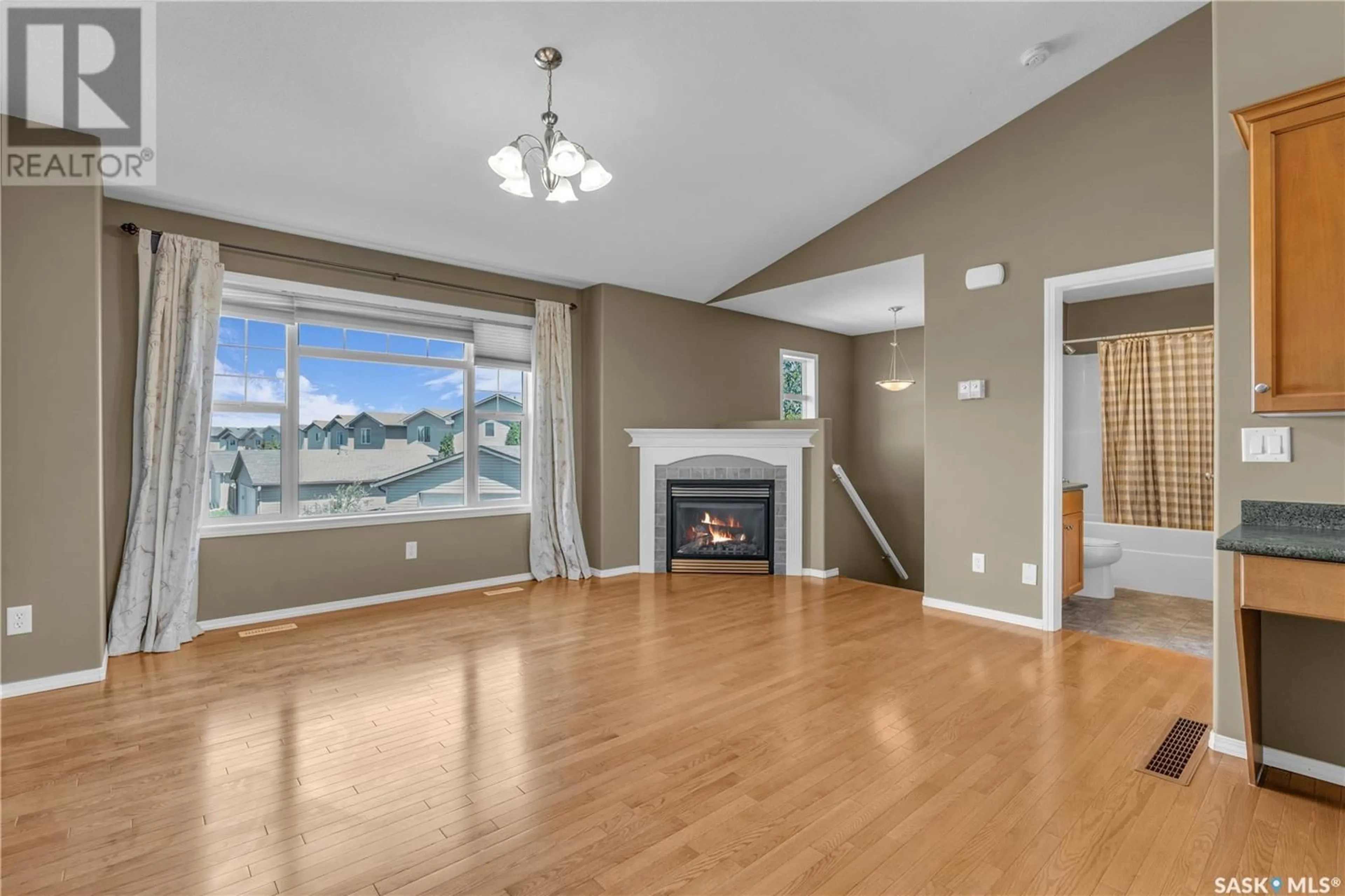 Living room with furniture, wood/laminate floor for 410 - 116 STENSRUD ROAD, Saskatoon Saskatchewan S7W0B7