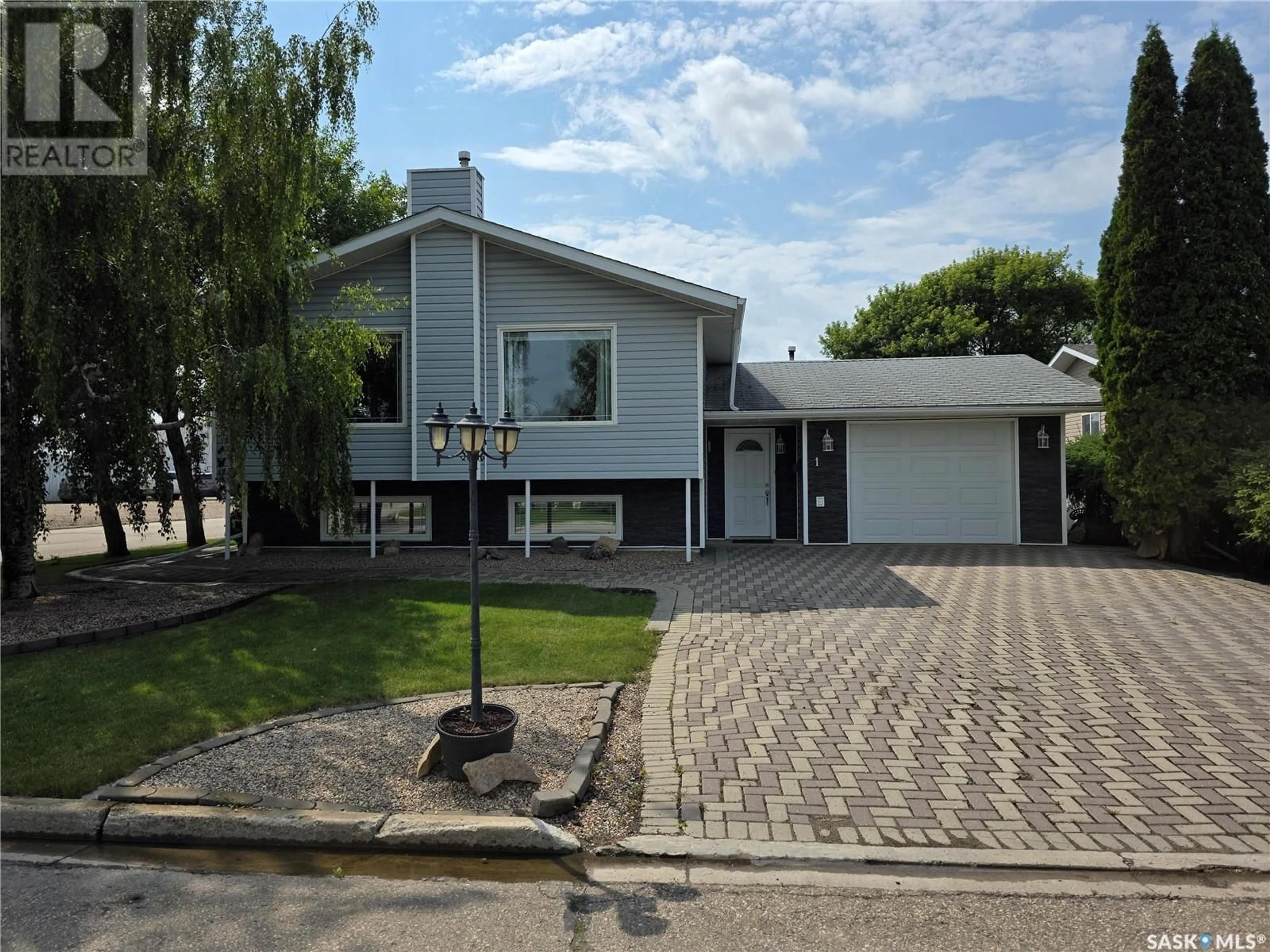 Home with vinyl exterior material, street for 1 VALECREST PLACE, Tisdale Saskatchewan S0E1T0