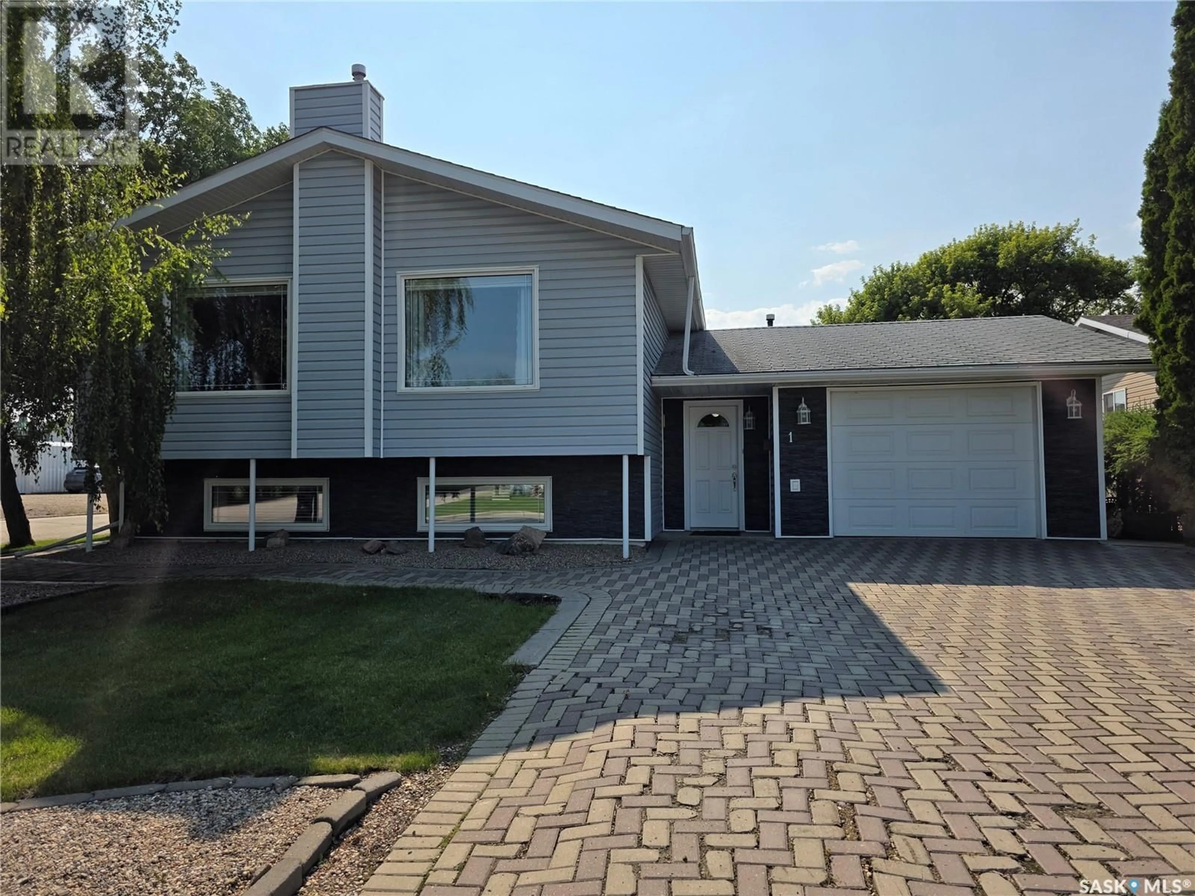 Home with vinyl exterior material, street for 1 VALECREST PLACE, Tisdale Saskatchewan S0E1T0
