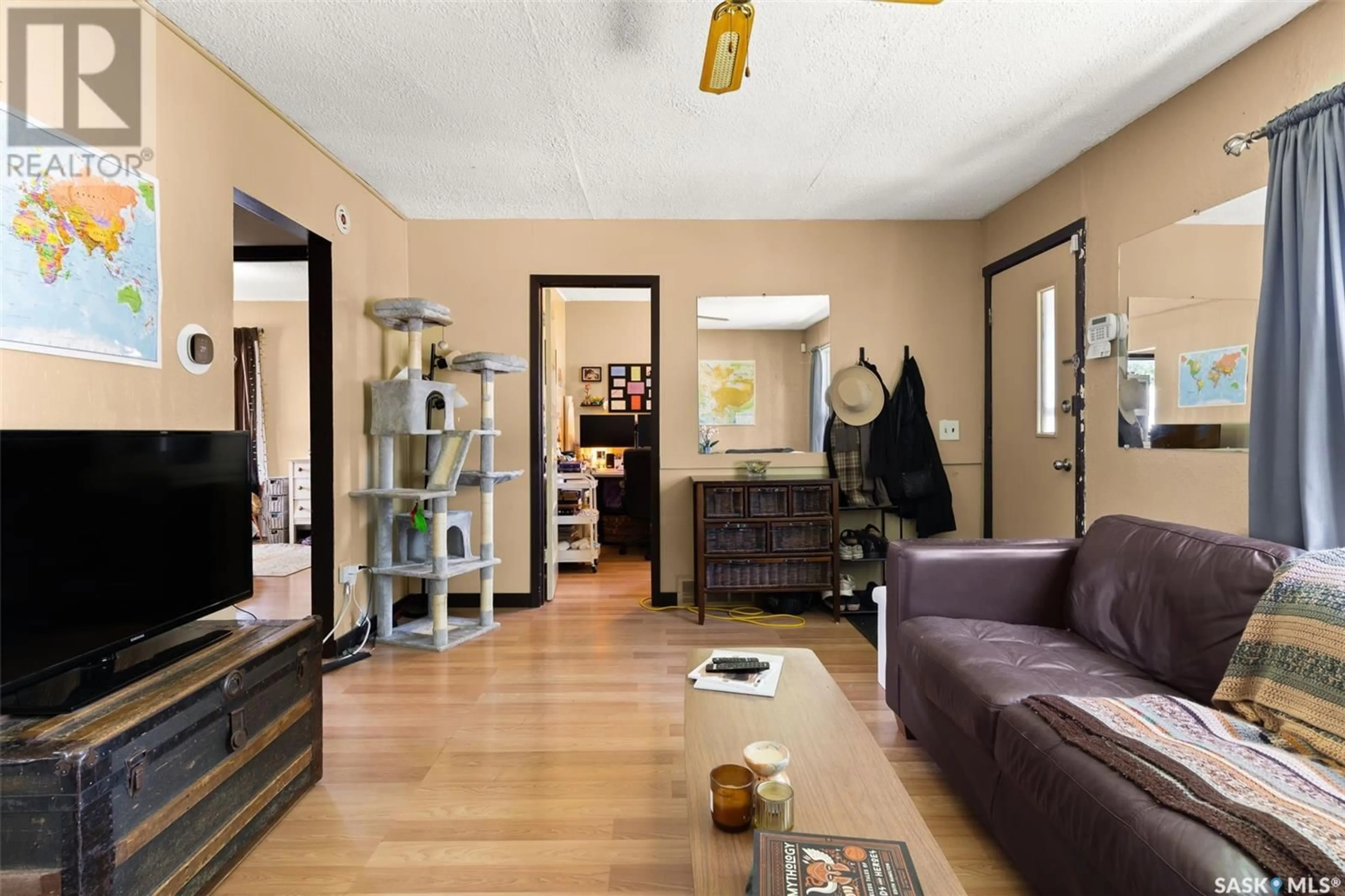 Living room with furniture, wood/laminate floor for 1649 GARNET STREET, Regina Saskatchewan S4T2Z1
