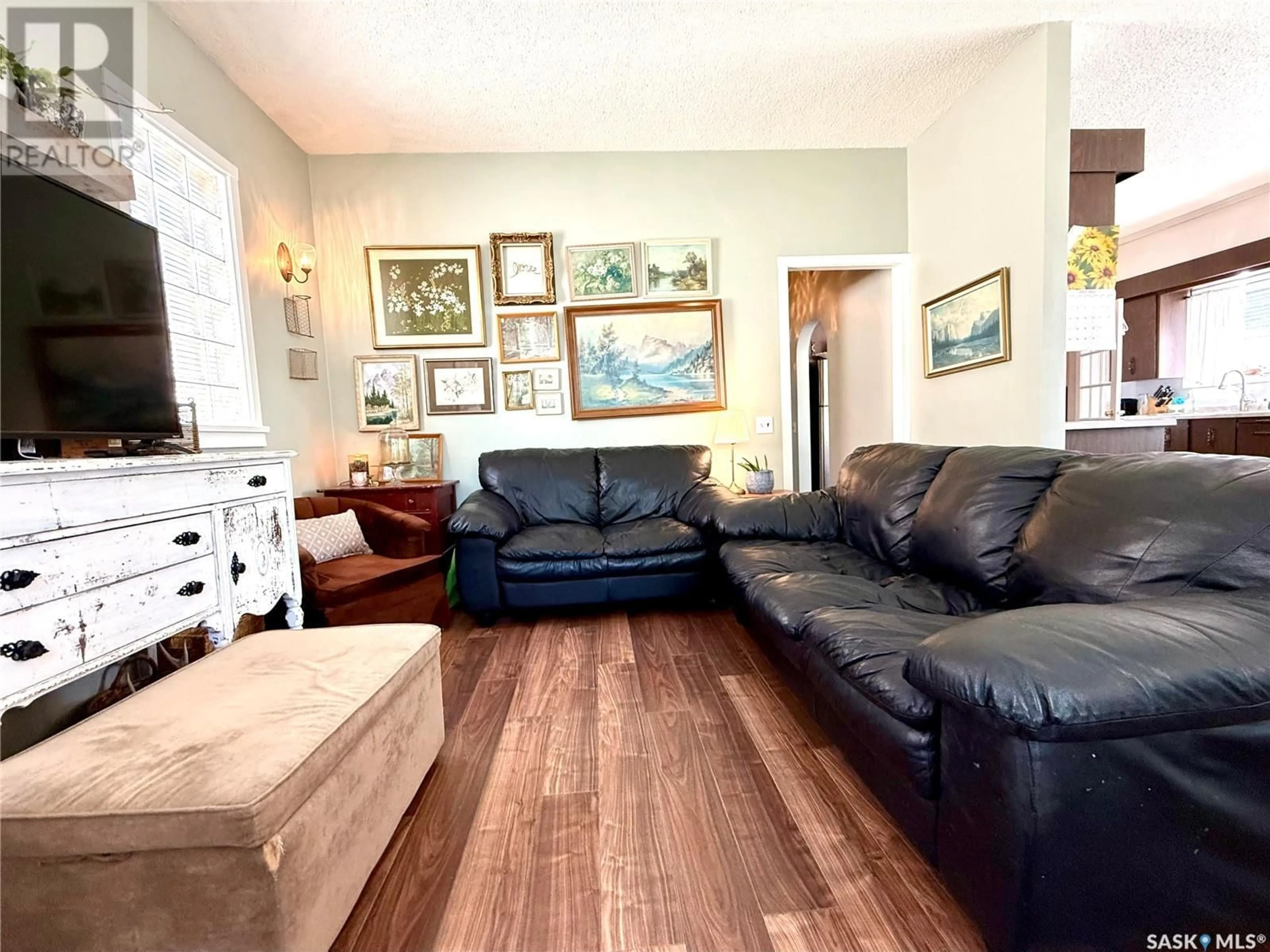 Living room with furniture, wood/laminate floor for W - 136 EIGHTH AVENUE, Melville Saskatchewan S0A2P1