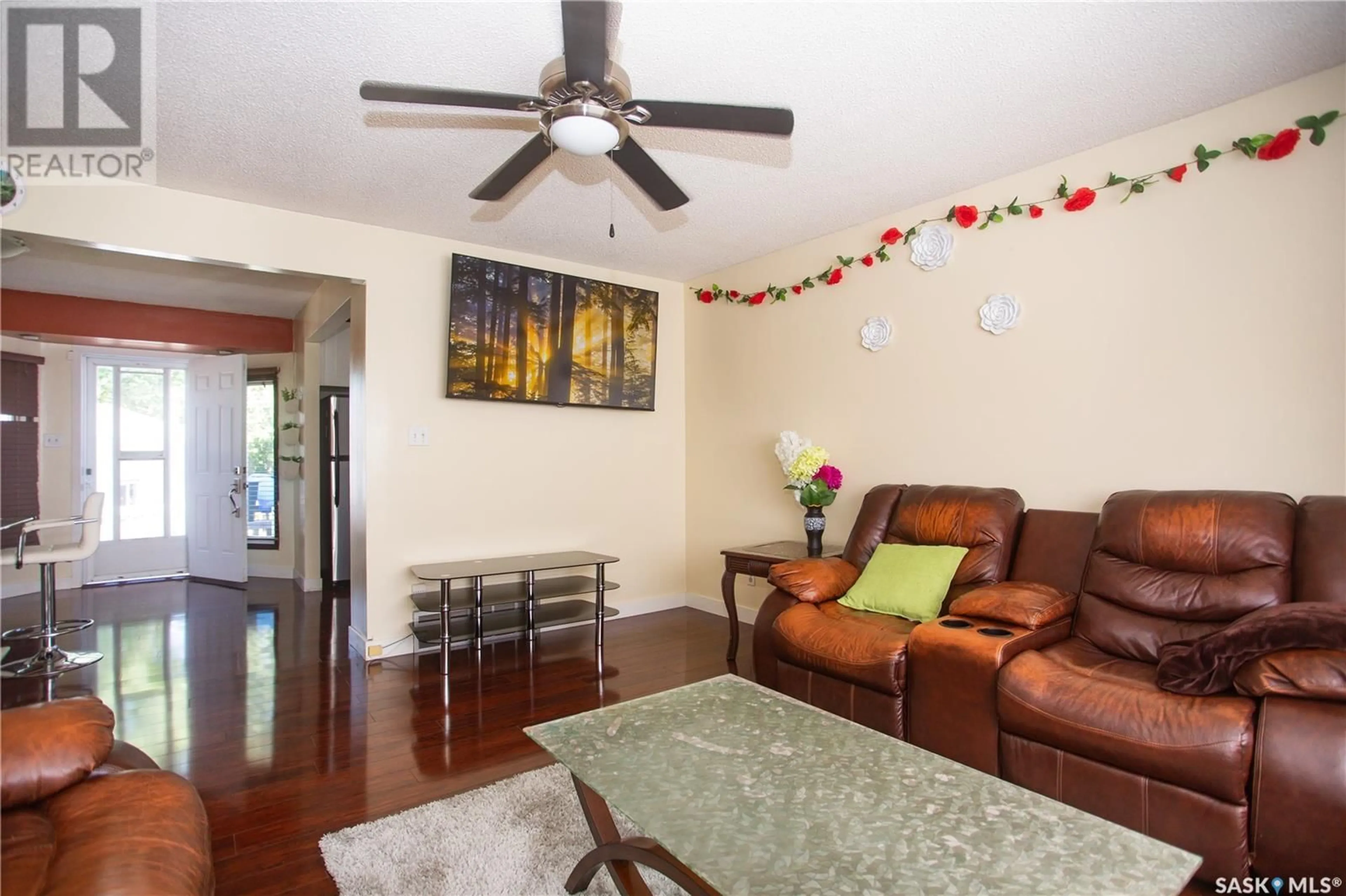 Living room with furniture, wood/laminate floor for 126 COOPER CRESCENT, Saskatoon Saskatchewan S7M4L3