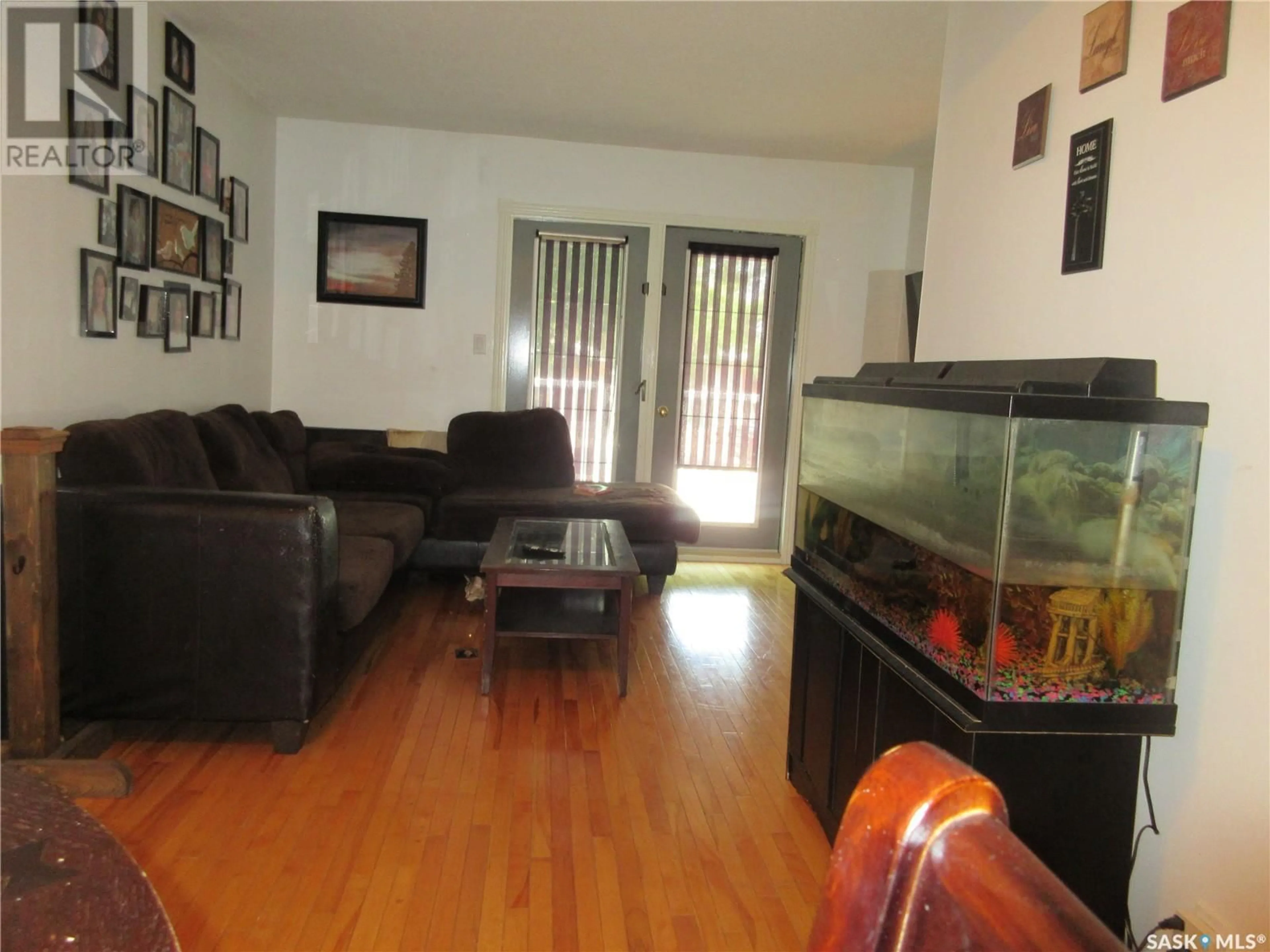 Living room with furniture, wood/laminate floor for 1341 LACON STREET, Regina Saskatchewan S4N1Y8