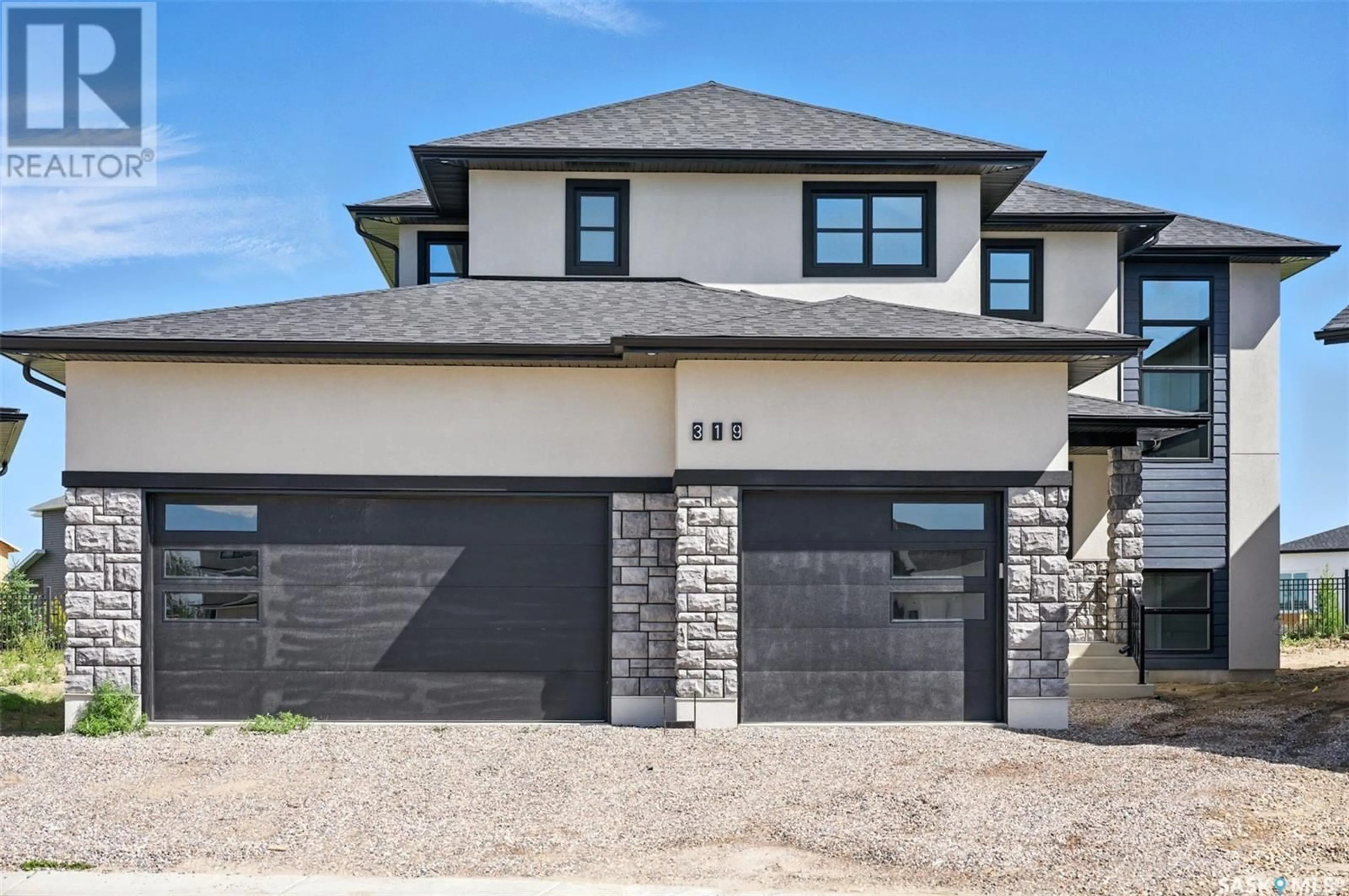 Home with brick exterior material, street for 319 WOOLF BAY, Saskatoon Saskatchewan S7W1E5