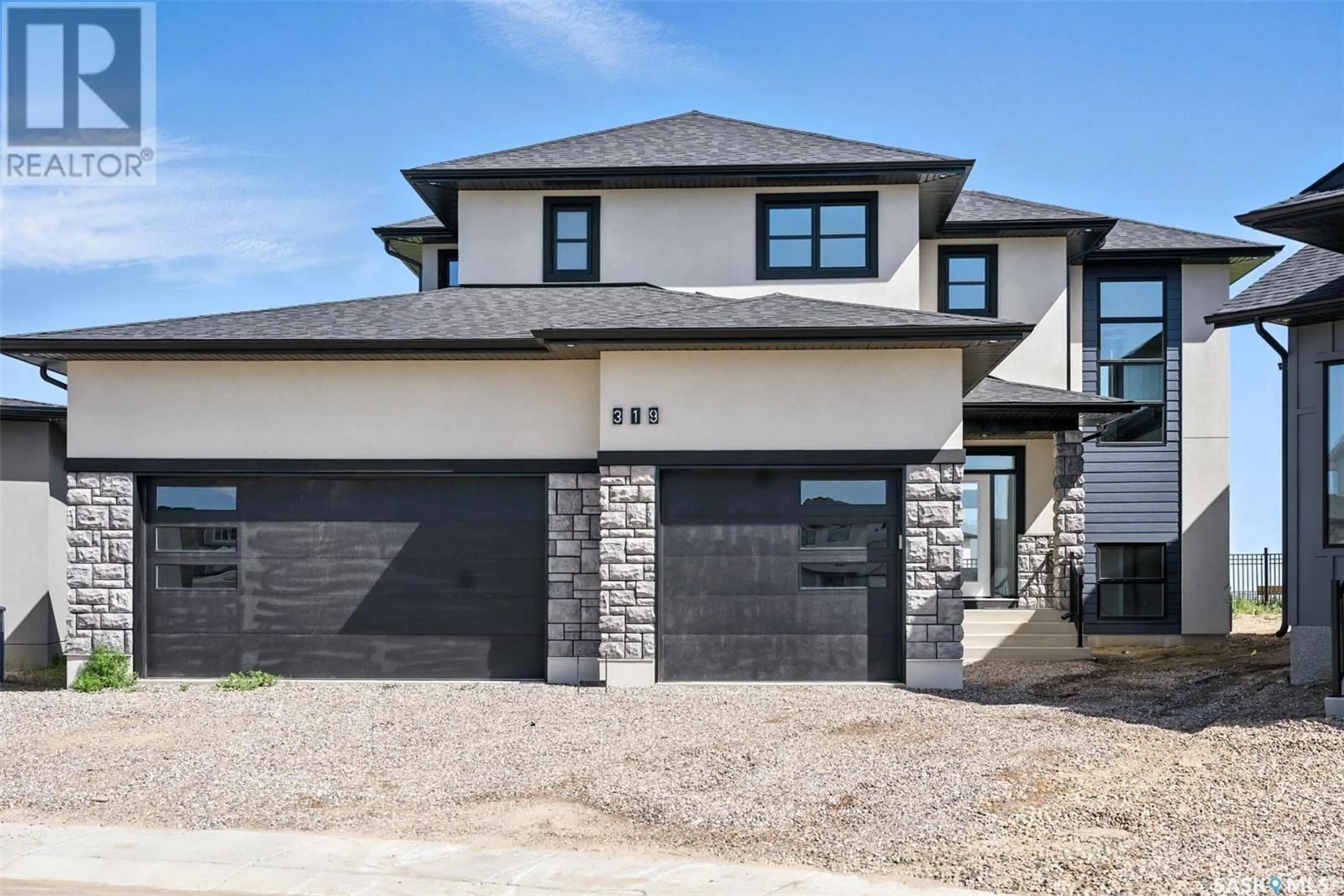 Home with brick exterior material, street for 319 WOOLF BAY, Saskatoon Saskatchewan S7W1E5