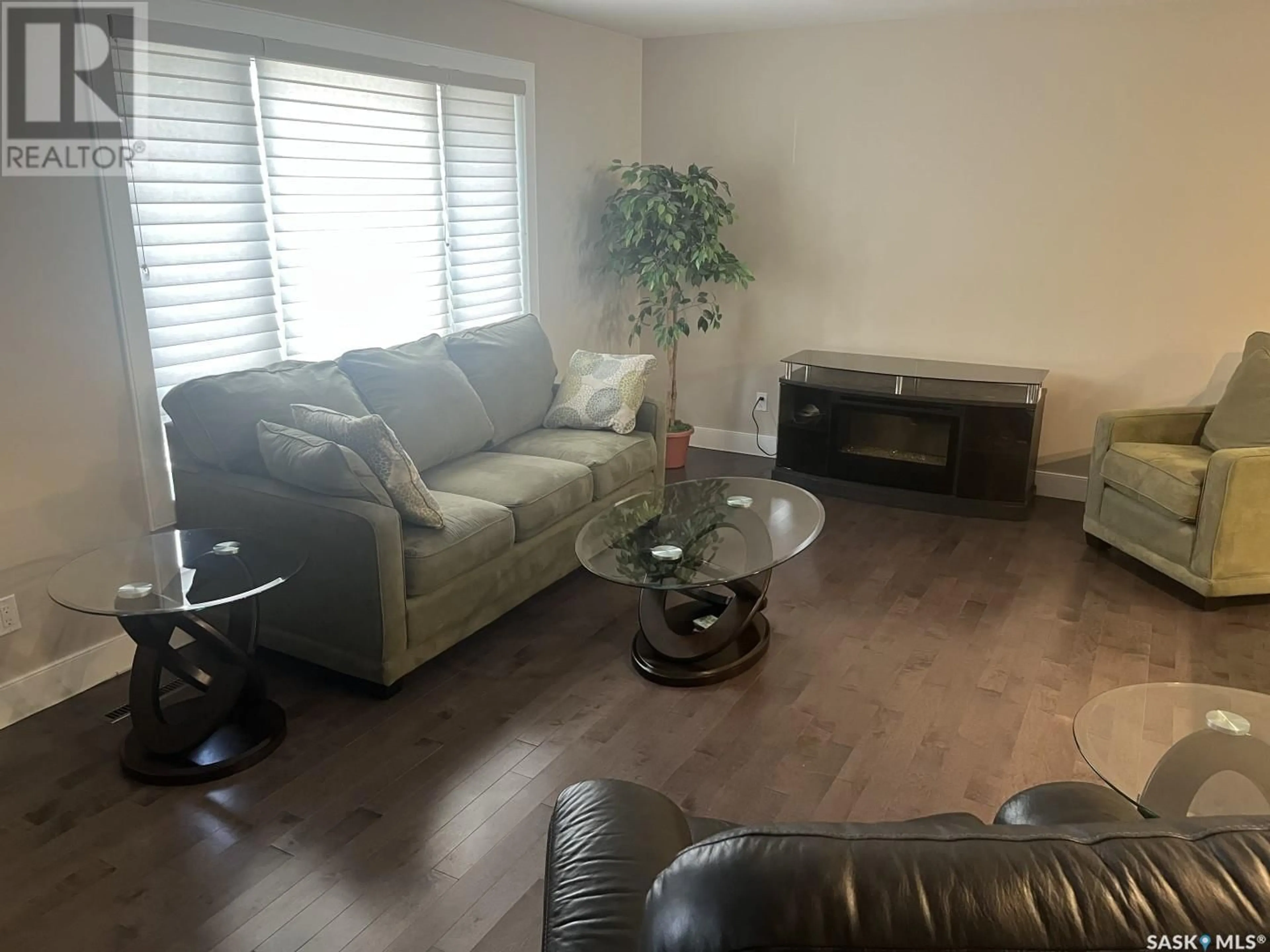 Living room with furniture, wood/laminate floor for 2117 STE CECILIA AVENUE, Saskatoon Saskatchewan S7M0P3