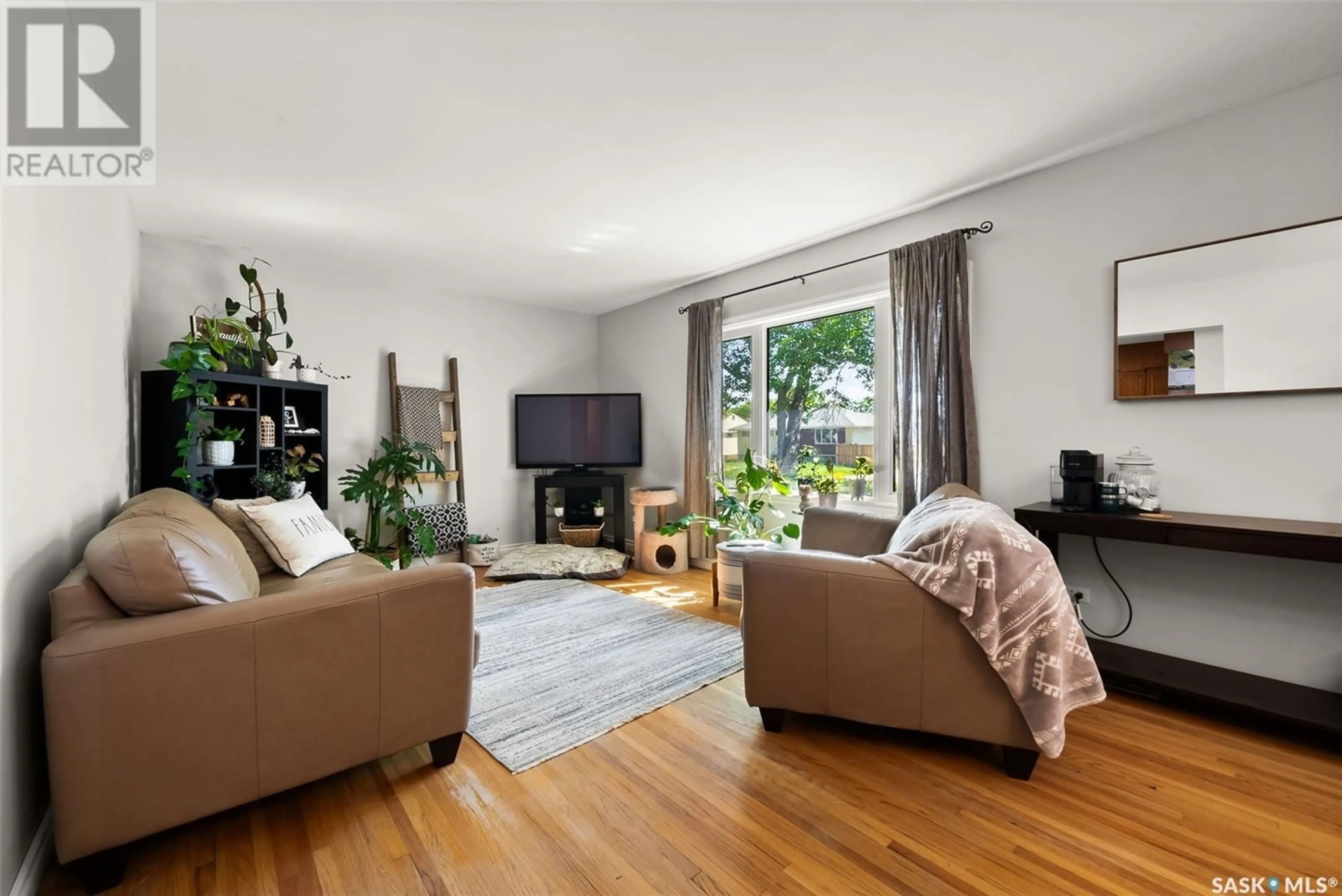 Living room with furniture, wood/laminate floor for 2746 ABBOTT ROAD, Regina Saskatchewan S4N2J6