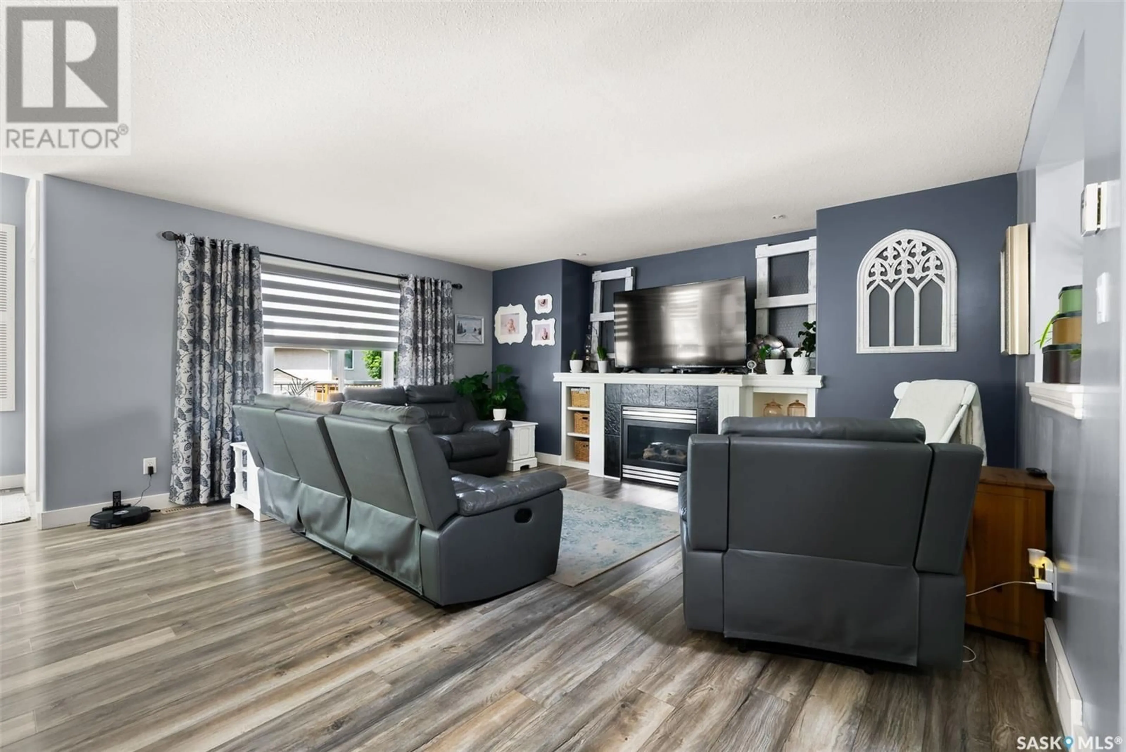 Living room with furniture, wood/laminate floor for 8026 FAIRWAYS WEST DRIVE, Regina Saskatchewan S4Y0A5