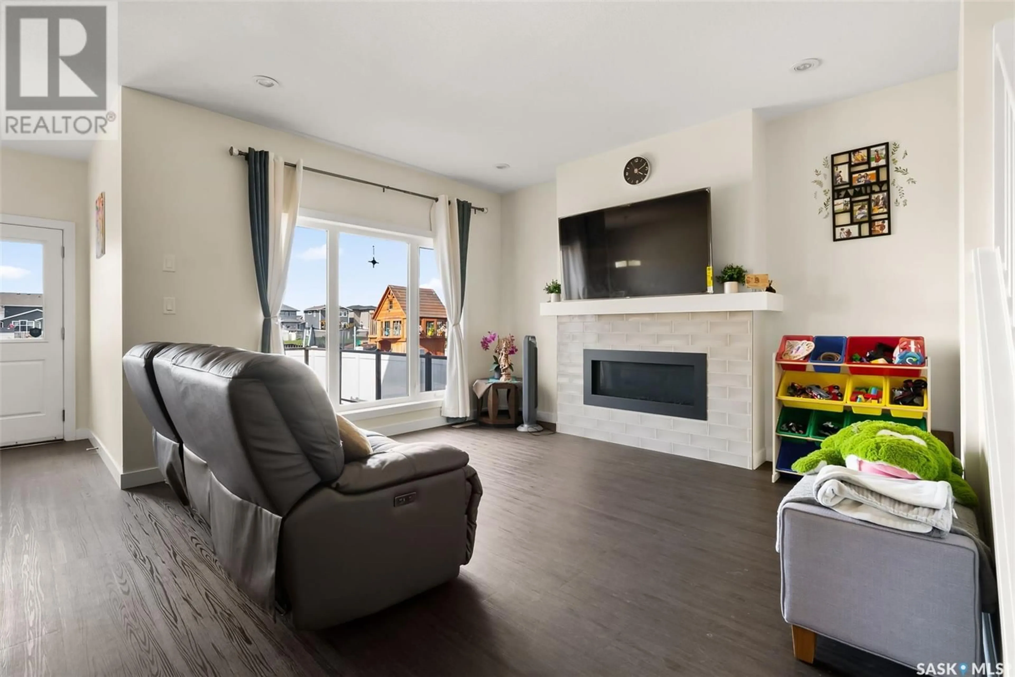 Living room with furniture, wood/laminate floor for 5561 NORSEMAN CRESCENT, Regina Saskatchewan S4W0J8