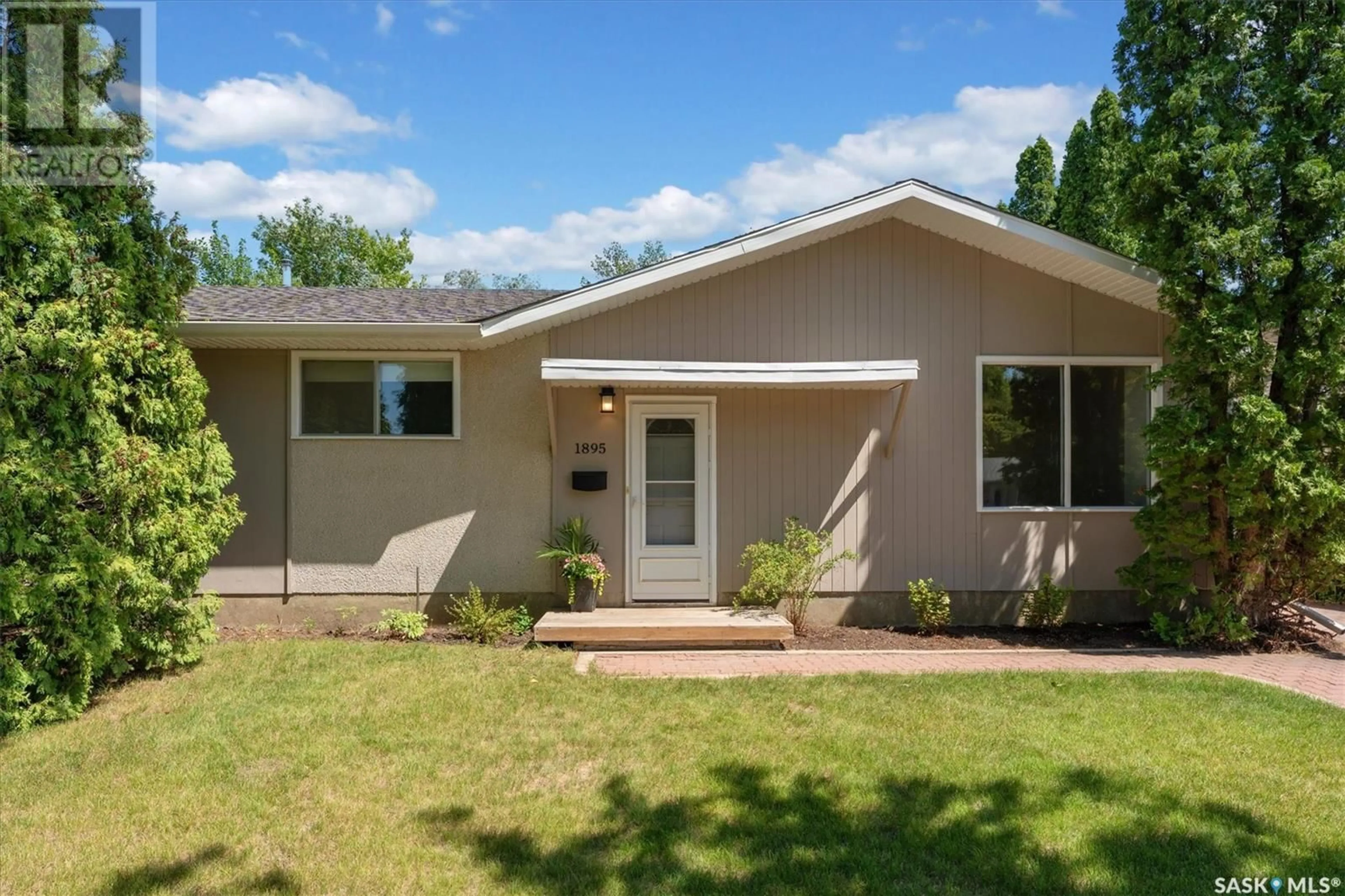 Home with vinyl exterior material, street for 1895 EASTHILL, Saskatoon Saskatchewan S7J3C2