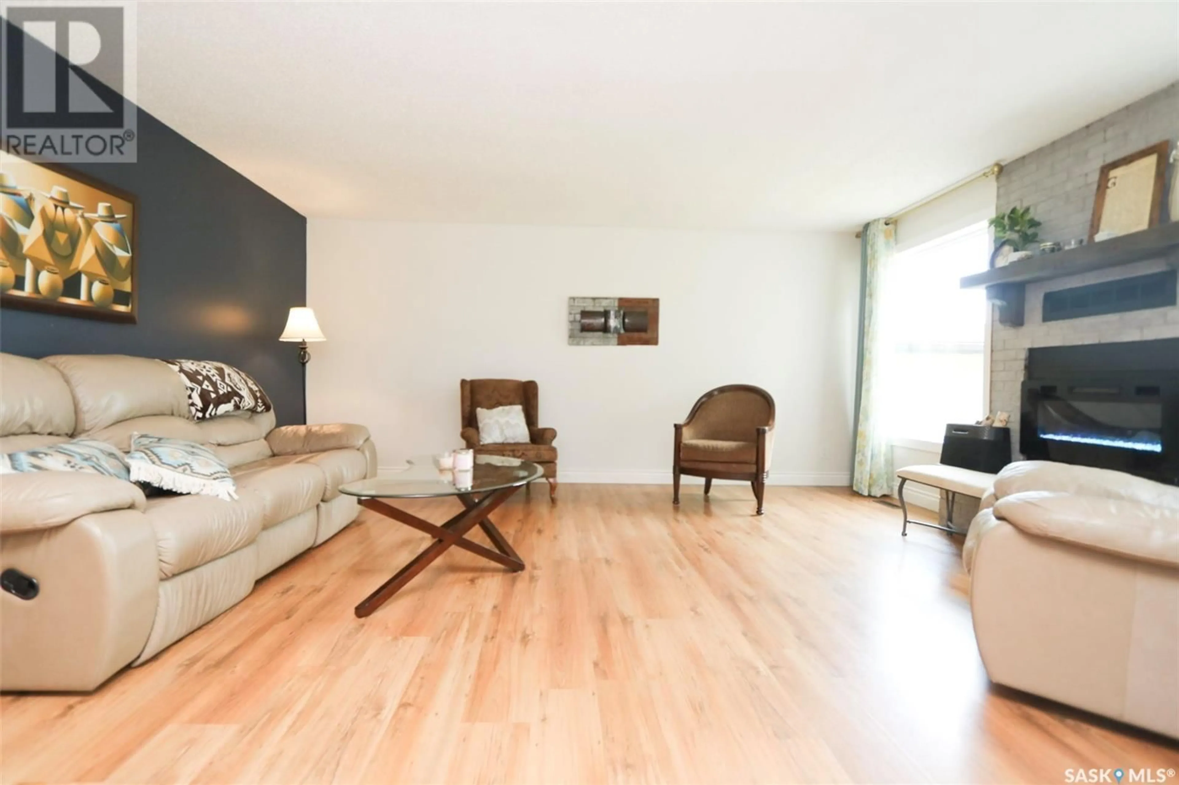 Living room with furniture, wood/laminate floor for 228 SUNSET DRIVE, Yorkton Saskatchewan S3N3R3