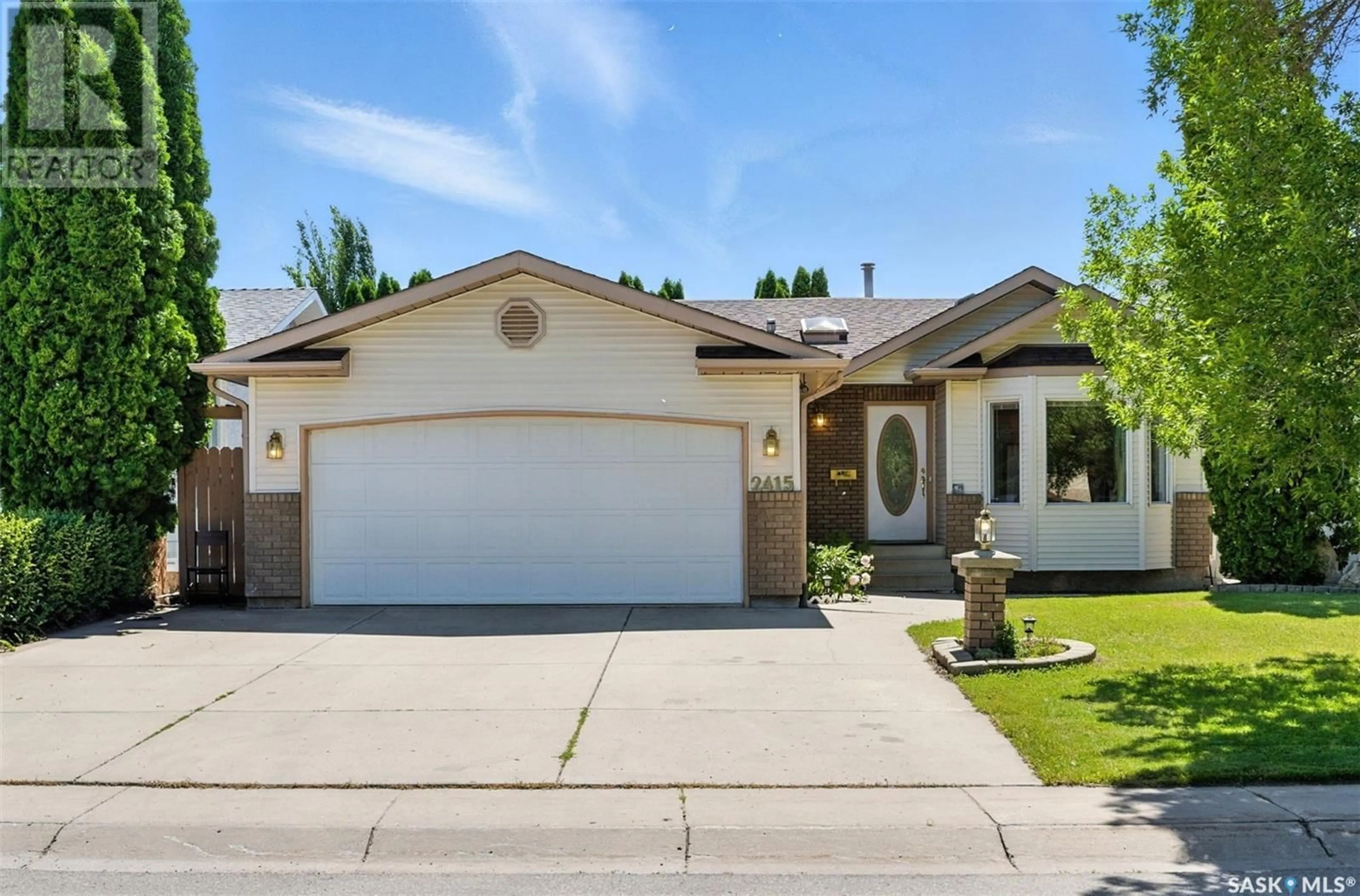 Home with vinyl exterior material, street for 2415 KENDERDINE ROAD, Saskatoon Saskatchewan S7N4A4