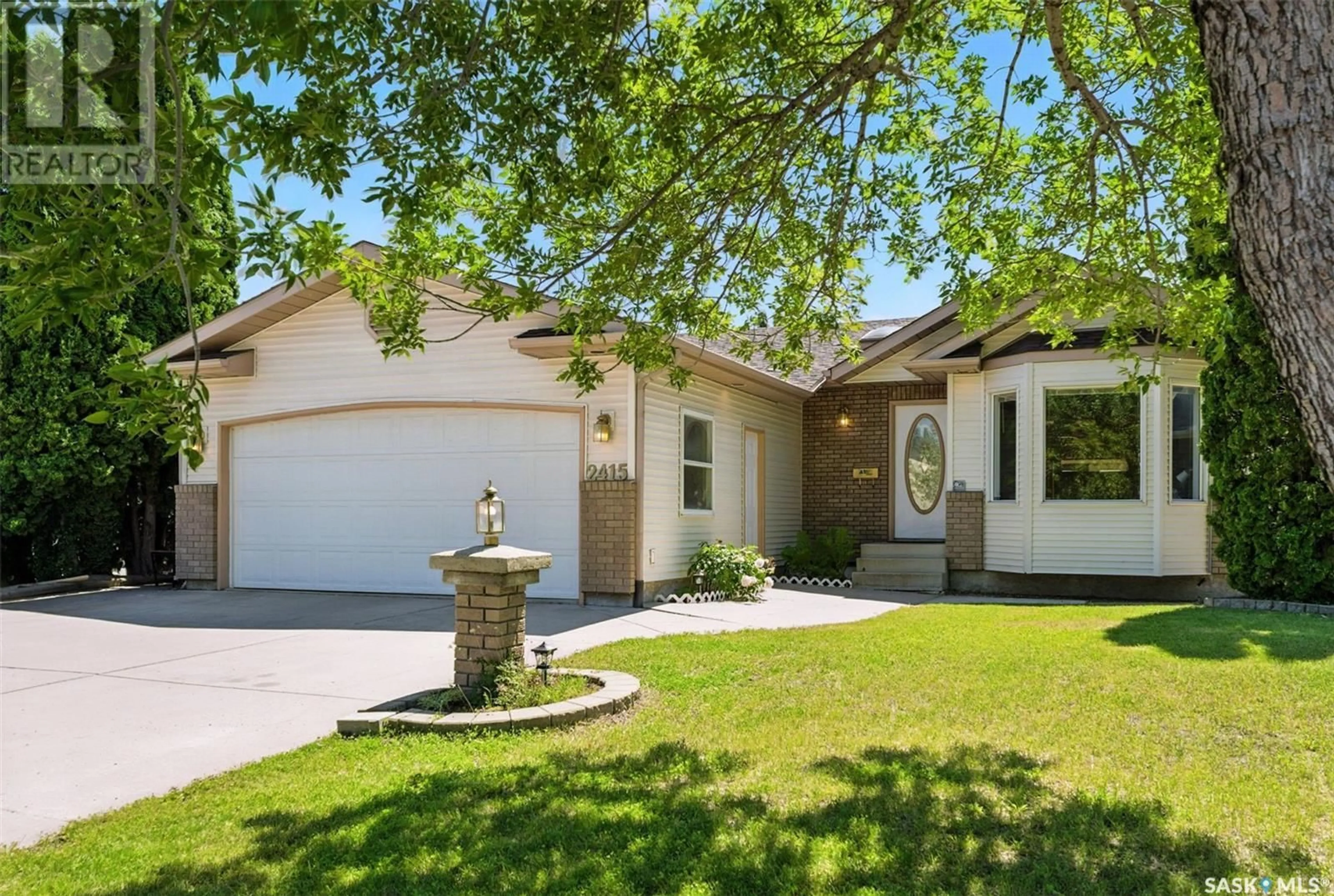 Home with vinyl exterior material, street for 2415 KENDERDINE ROAD, Saskatoon Saskatchewan S7N4A4