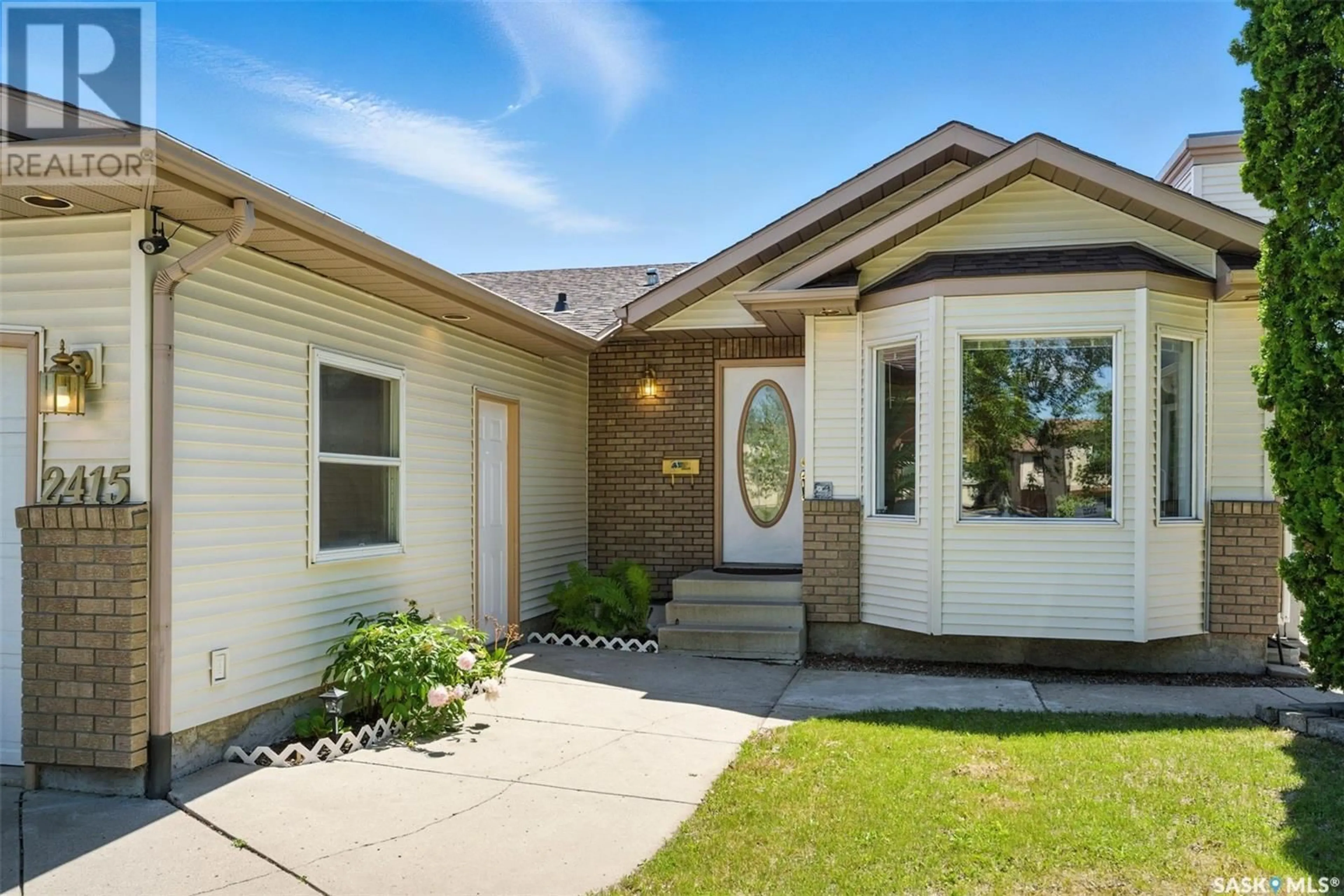 Home with vinyl exterior material, street for 2415 KENDERDINE ROAD, Saskatoon Saskatchewan S7N4A4