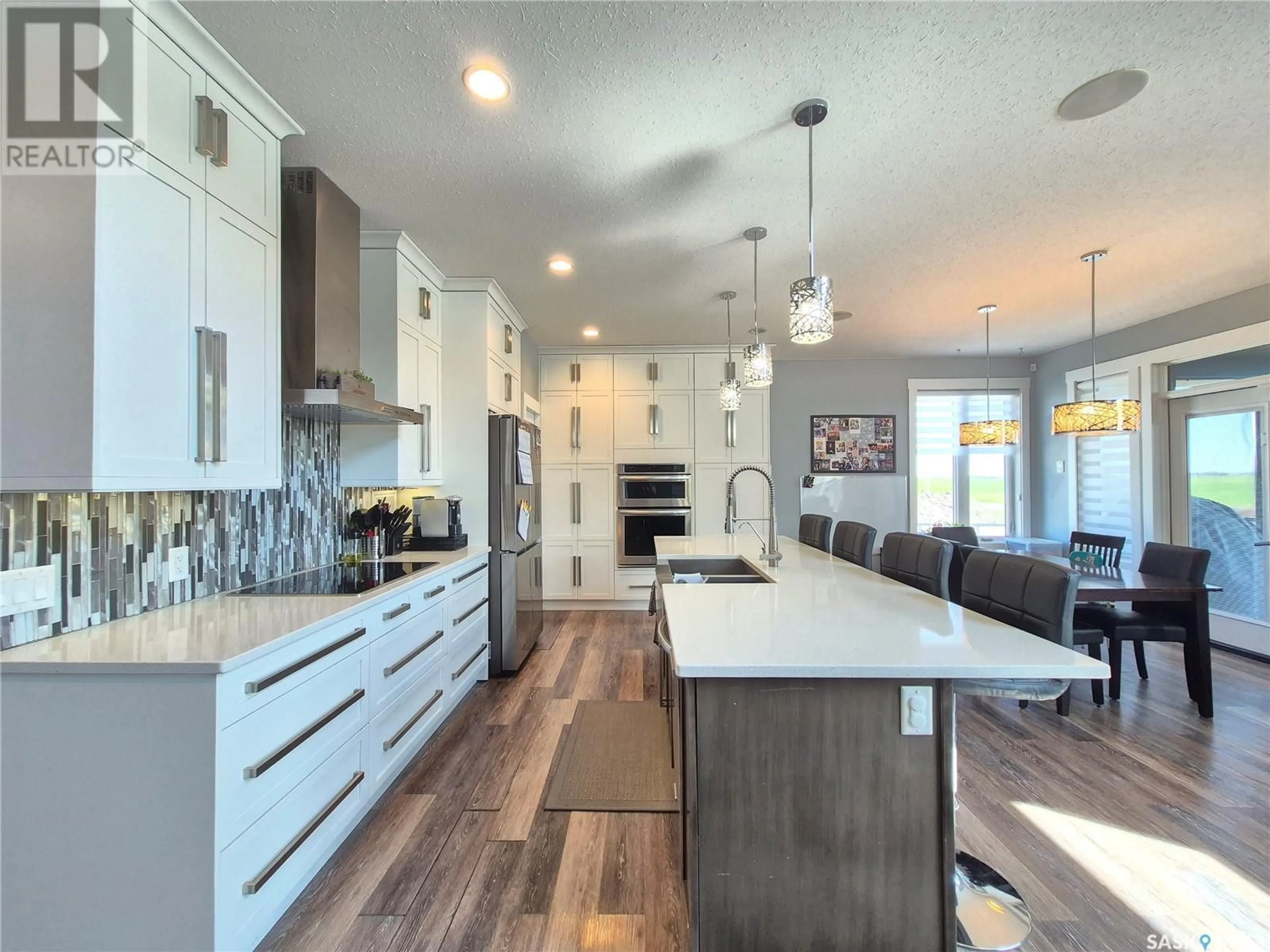 Open concept kitchen, wood/laminate floor for 836 MCTAGGART DRIVE, Weyburn Saskatchewan S4H3M6