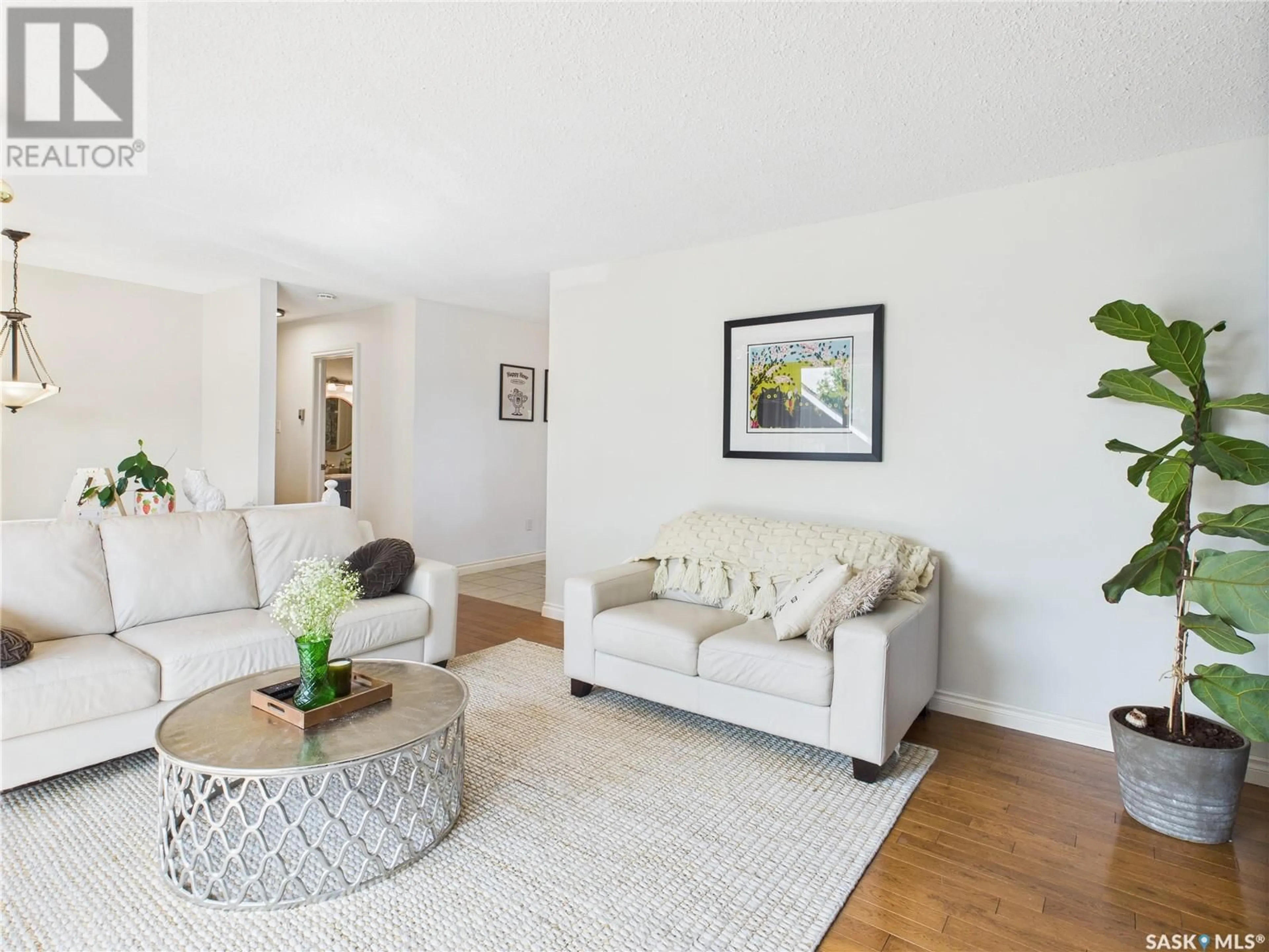 Living room with furniture, wood/laminate floor for 1316 REED BAY, Prince Albert Saskatchewan S6V6R4