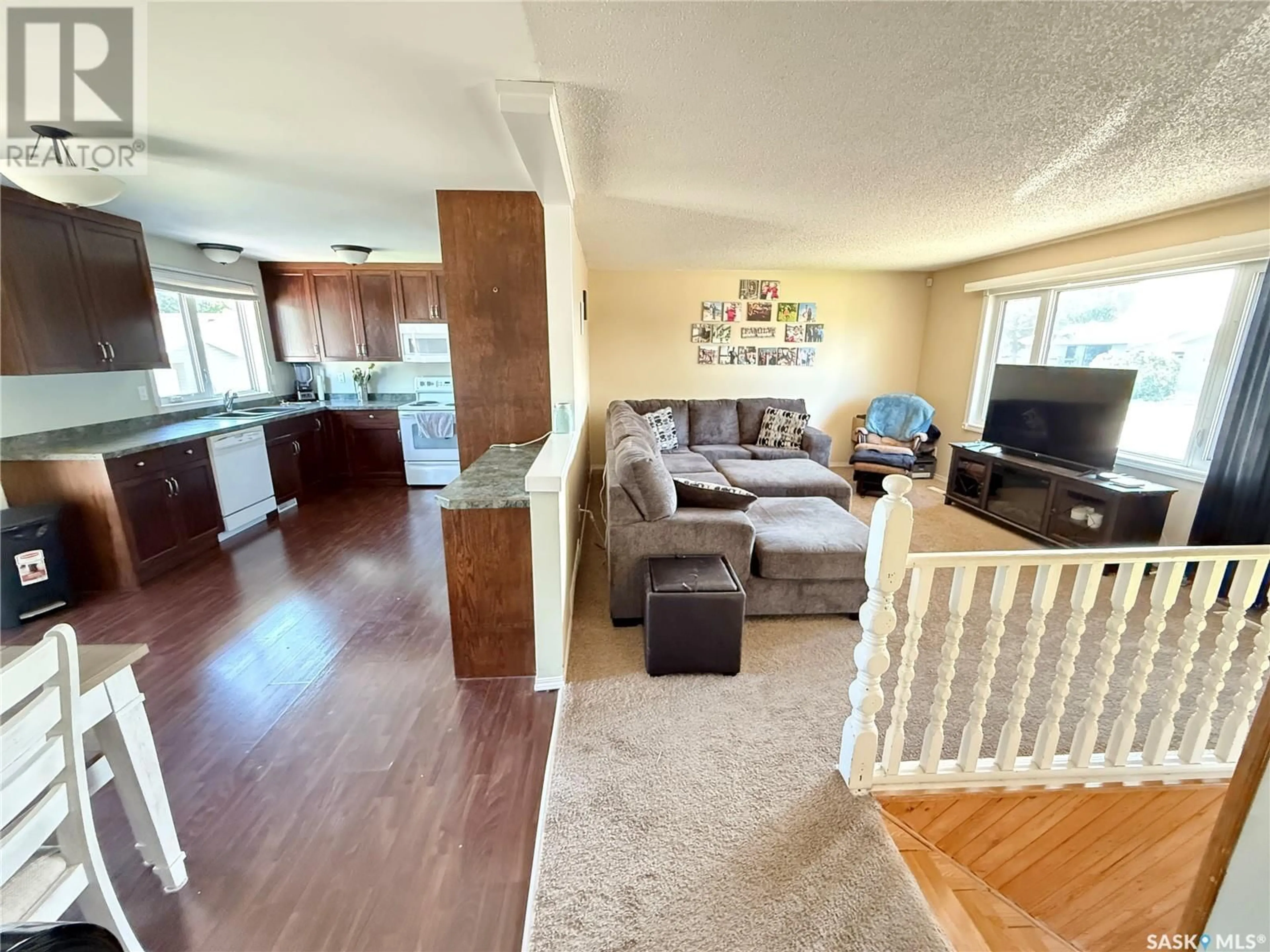 Living room with furniture, wood/laminate floor for 156 MONTGOMERY CRESCENT, Weyburn Saskatchewan S4H2X7