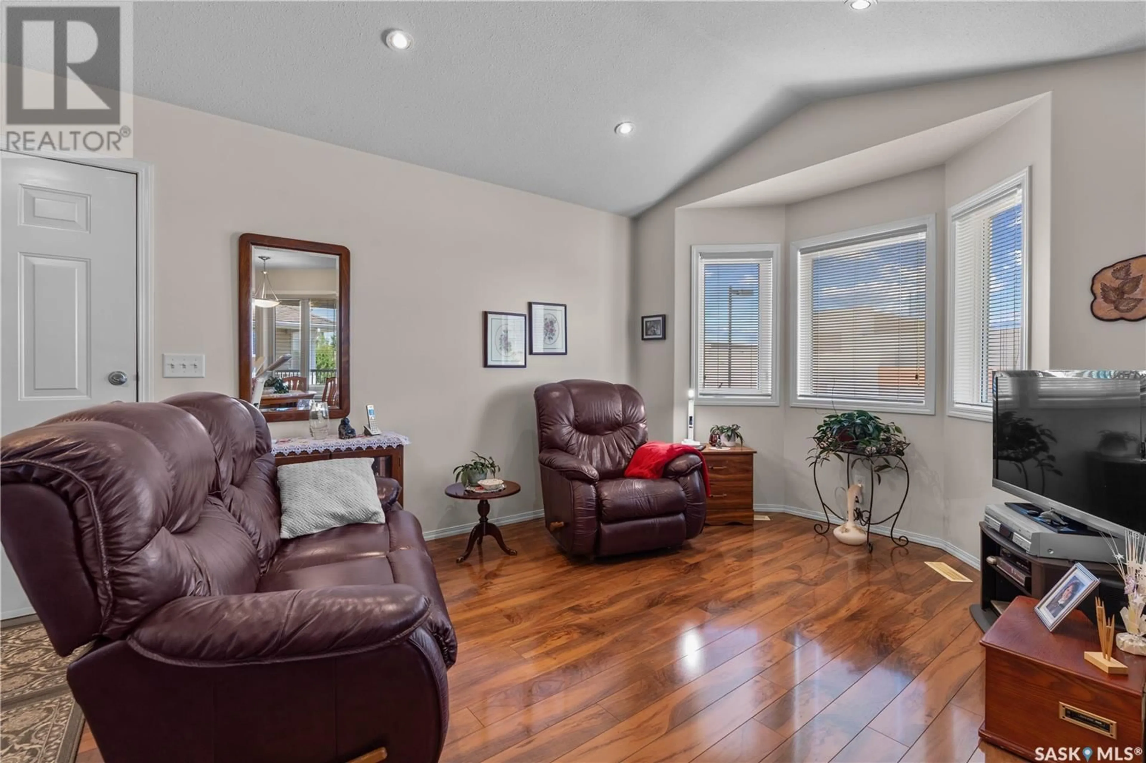 Living room with furniture, wood/laminate floor for 4040 BUCKINGHAM DRIVE, Regina Saskatchewan S4V3A9