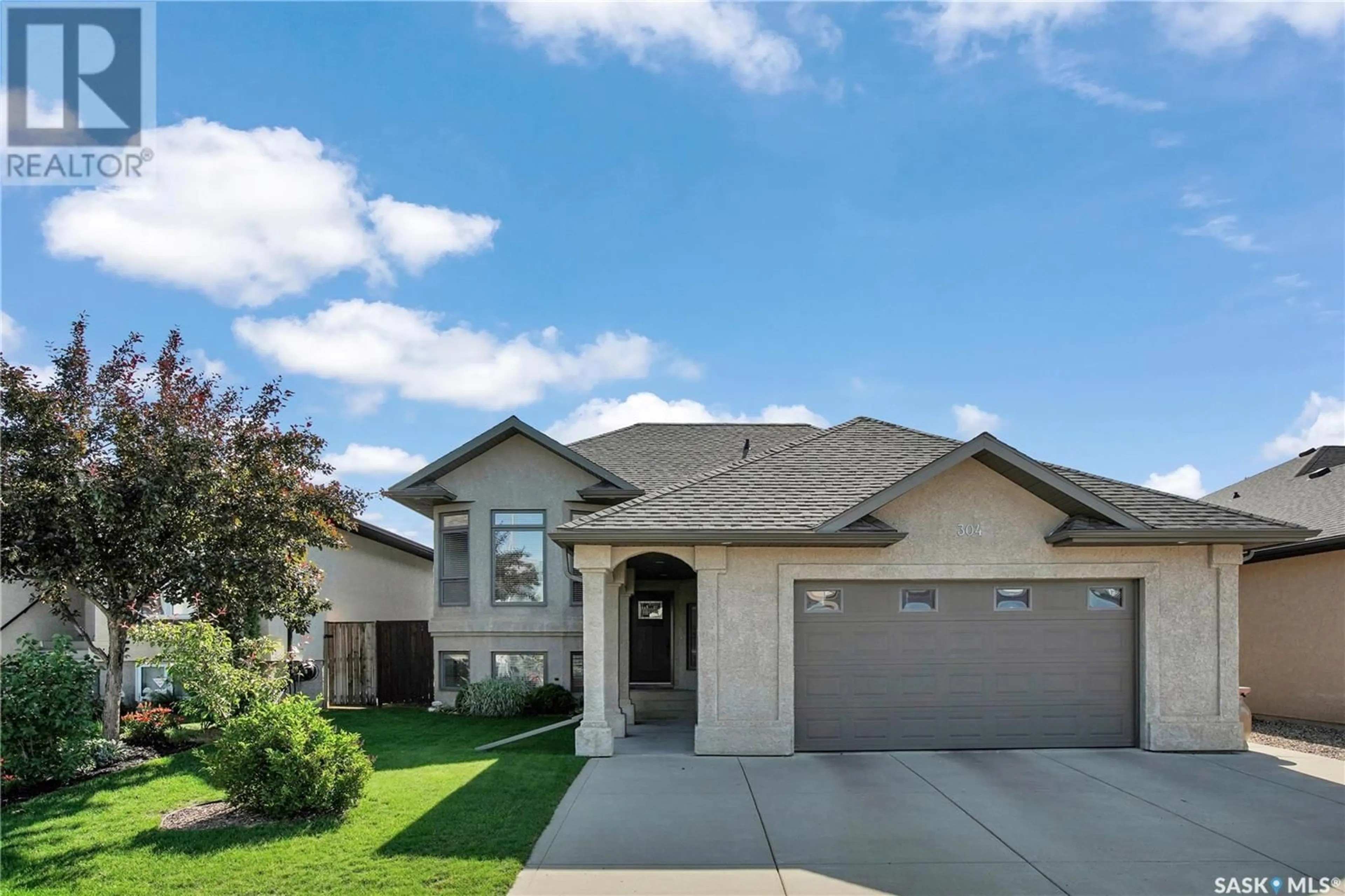 Home with brick exterior material, street for 304 CORNERBROOK COURT, Warman Saskatchewan S0K0A1