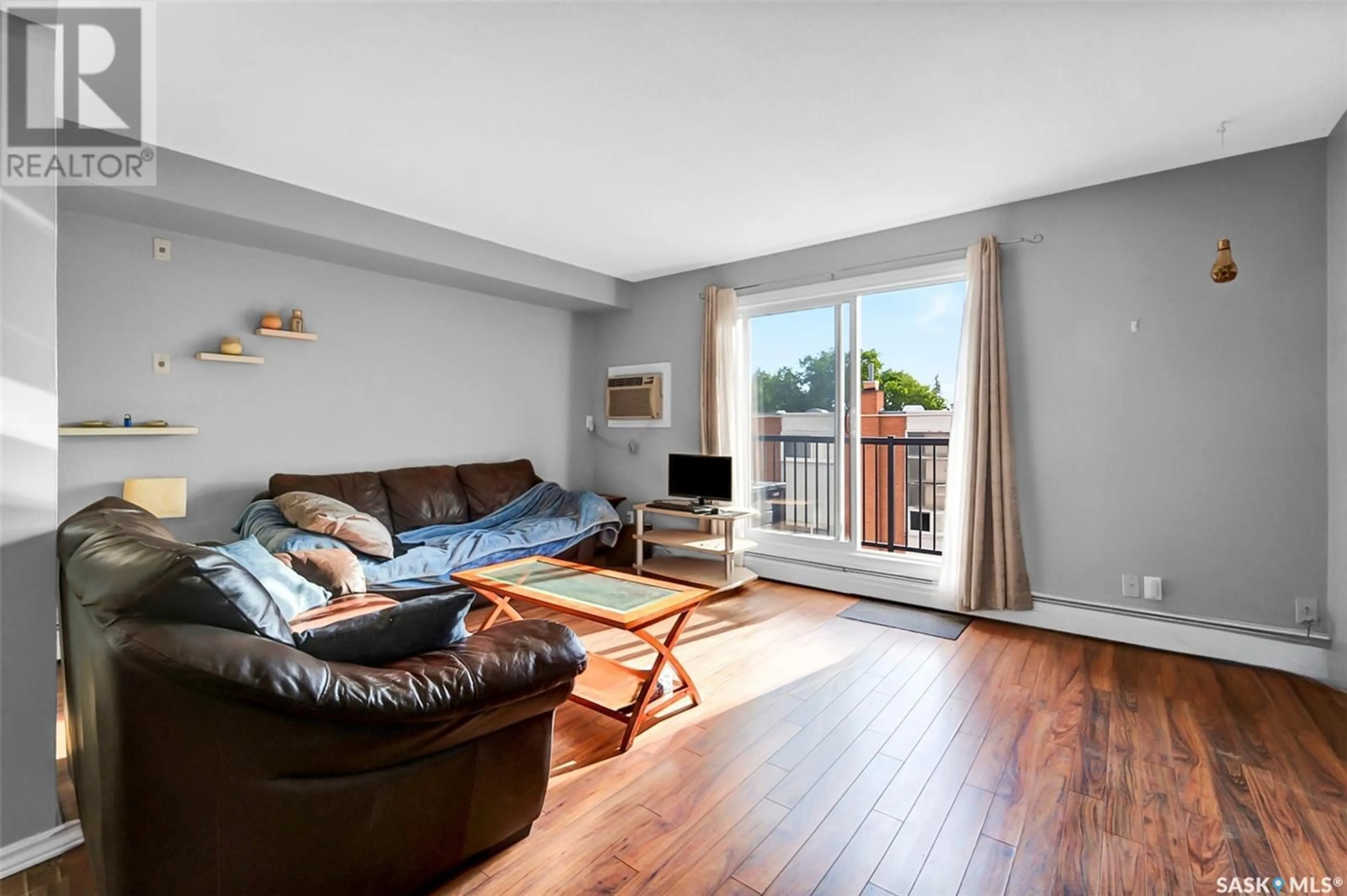 Living room with furniture, wood/laminate floor for 17 3030 ARLINGTON AVENUE, Saskatoon Saskatchewan S7J2J9