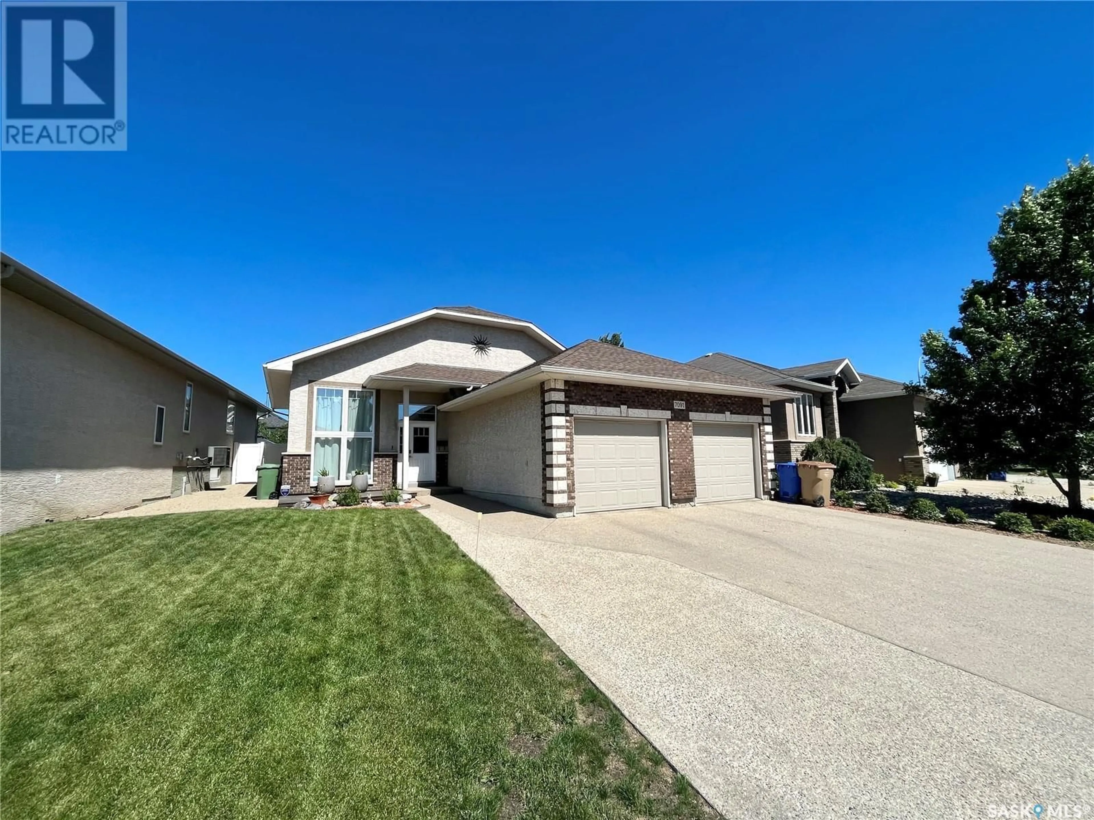 Home with vinyl exterior material, street for 7091 MAPLE RIDGE DRIVE, Regina Saskatchewan S4X0B2