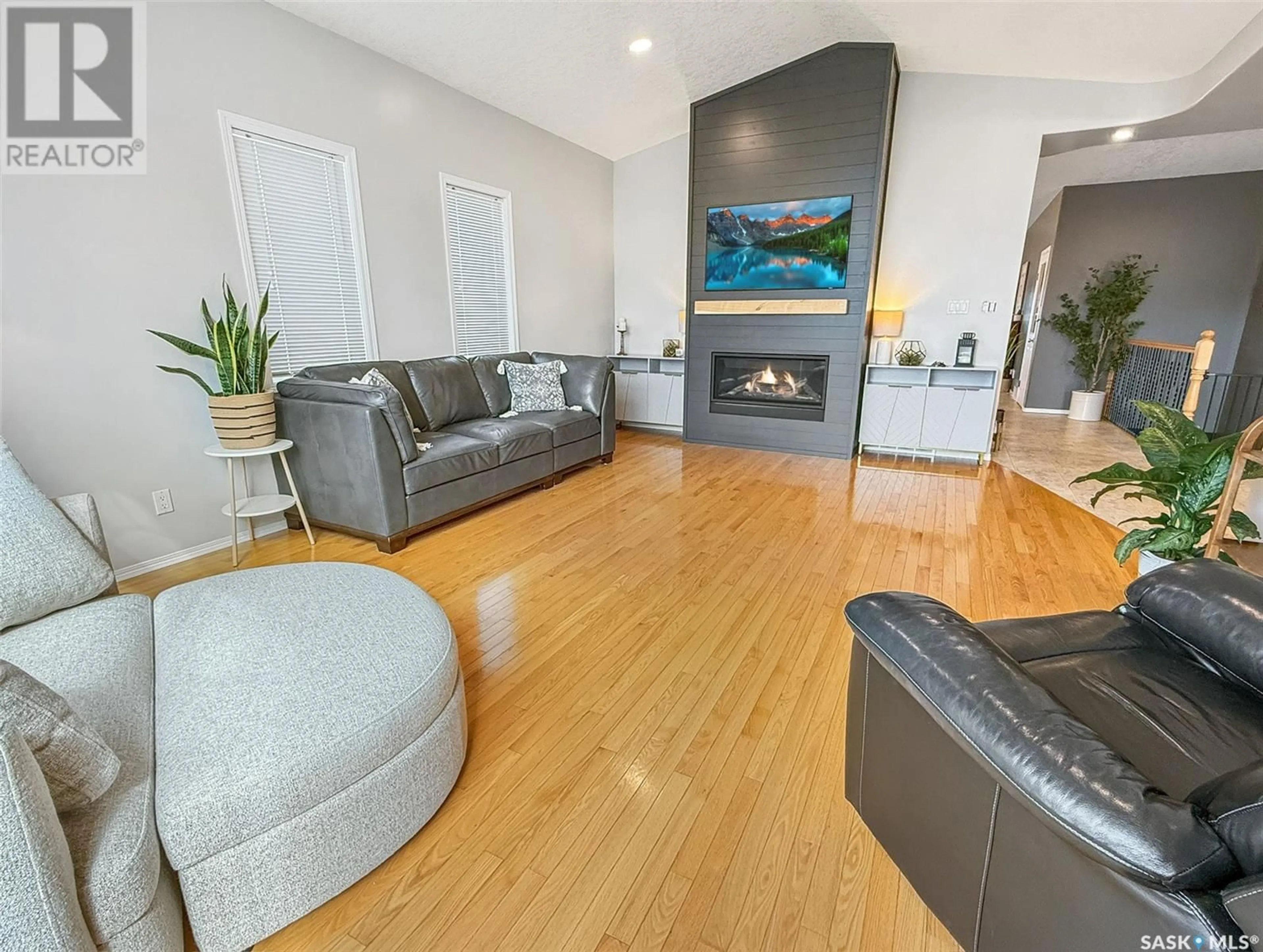 Living room with furniture, wood/laminate floor for 1005 2ND AVENUE, Swift Current Saskatchewan S9H4T2