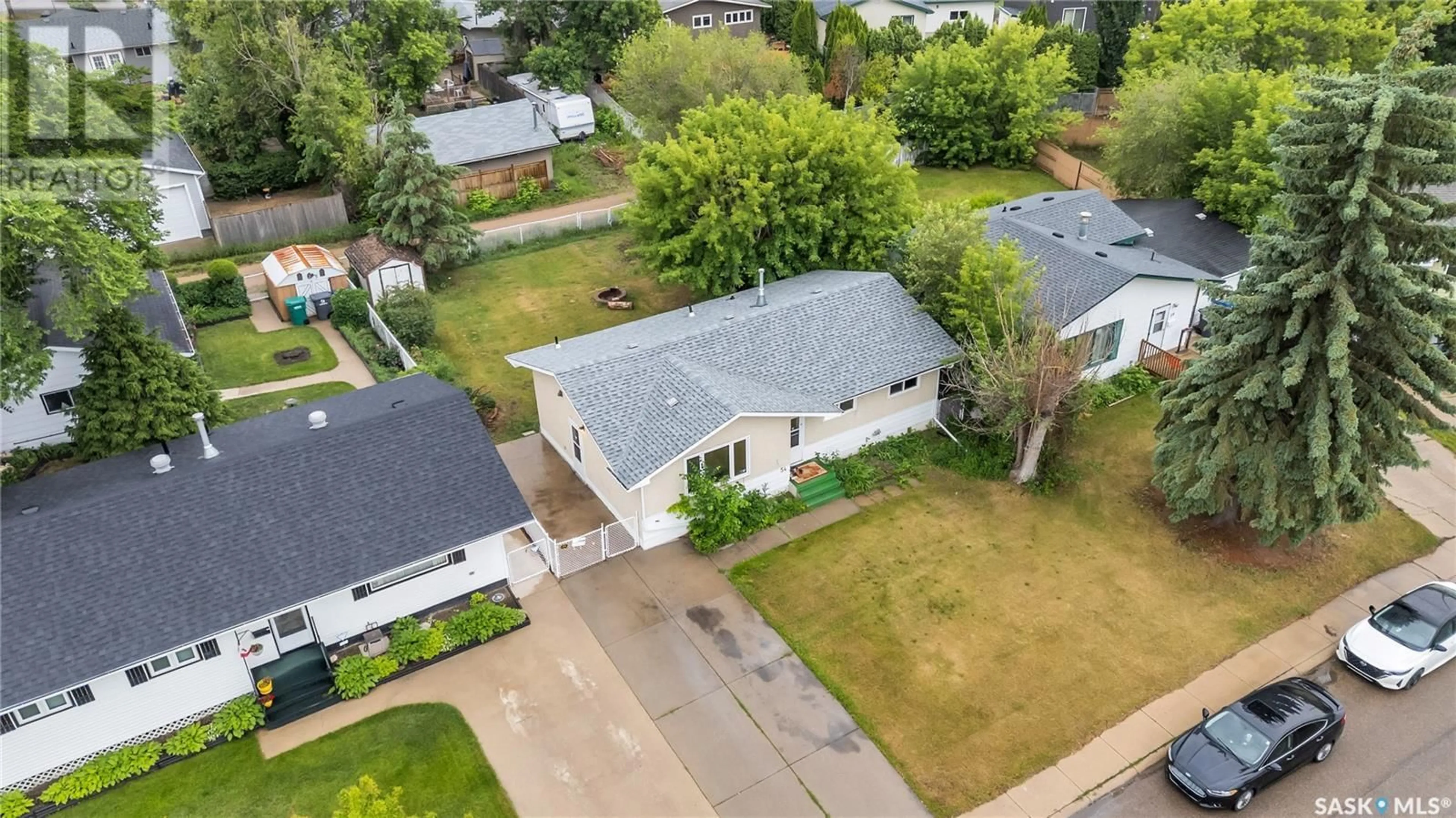 A pic from outside/outdoor area/front of a property/back of a property/a pic from drone, street for 54 MACKIE CRESCENT, Saskatoon Saskatchewan S7L3V3