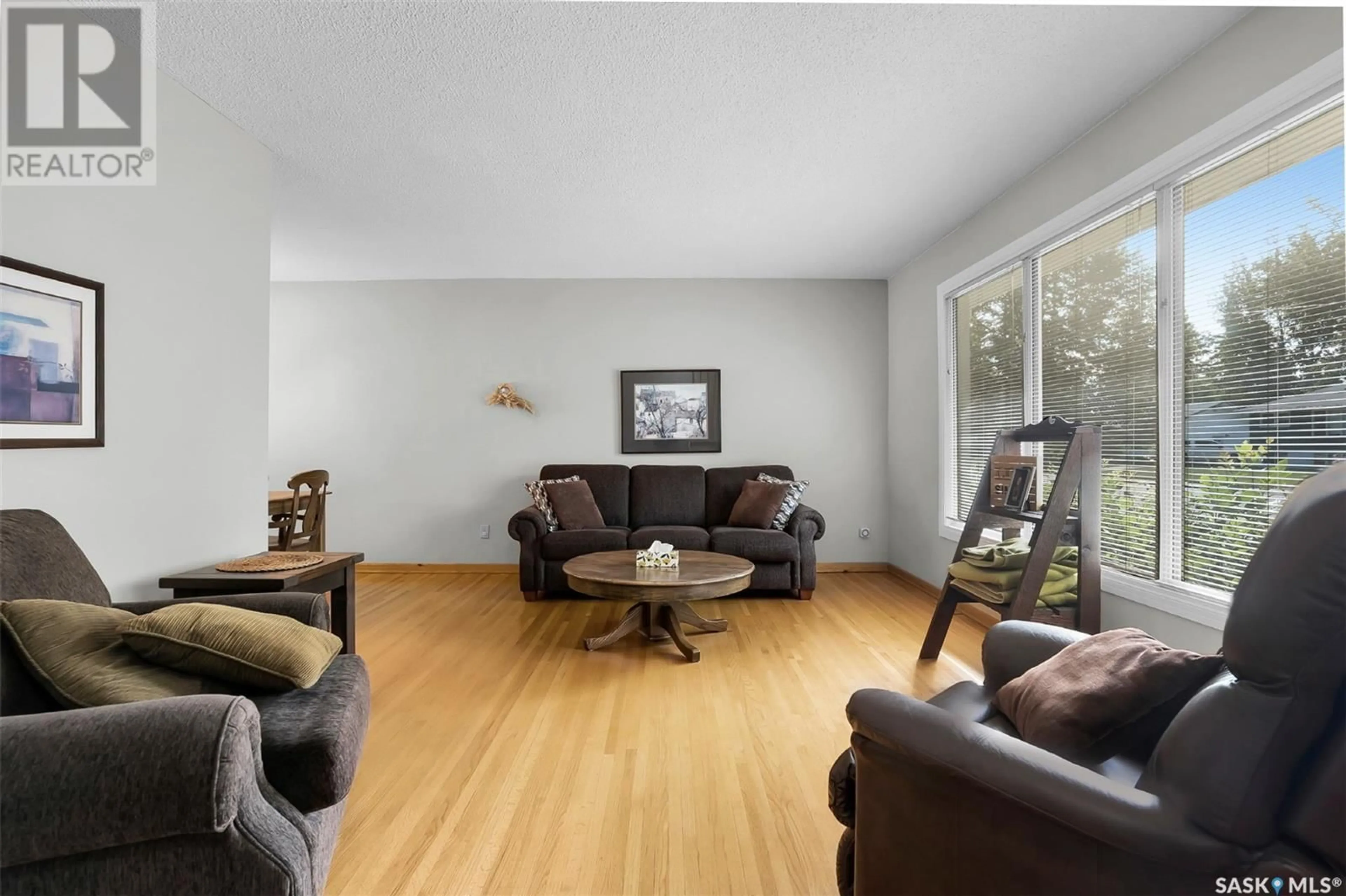 Living room with furniture, wood/laminate floor for 309 CASCADE STREET, Saskatoon Saskatchewan S7J0M4
