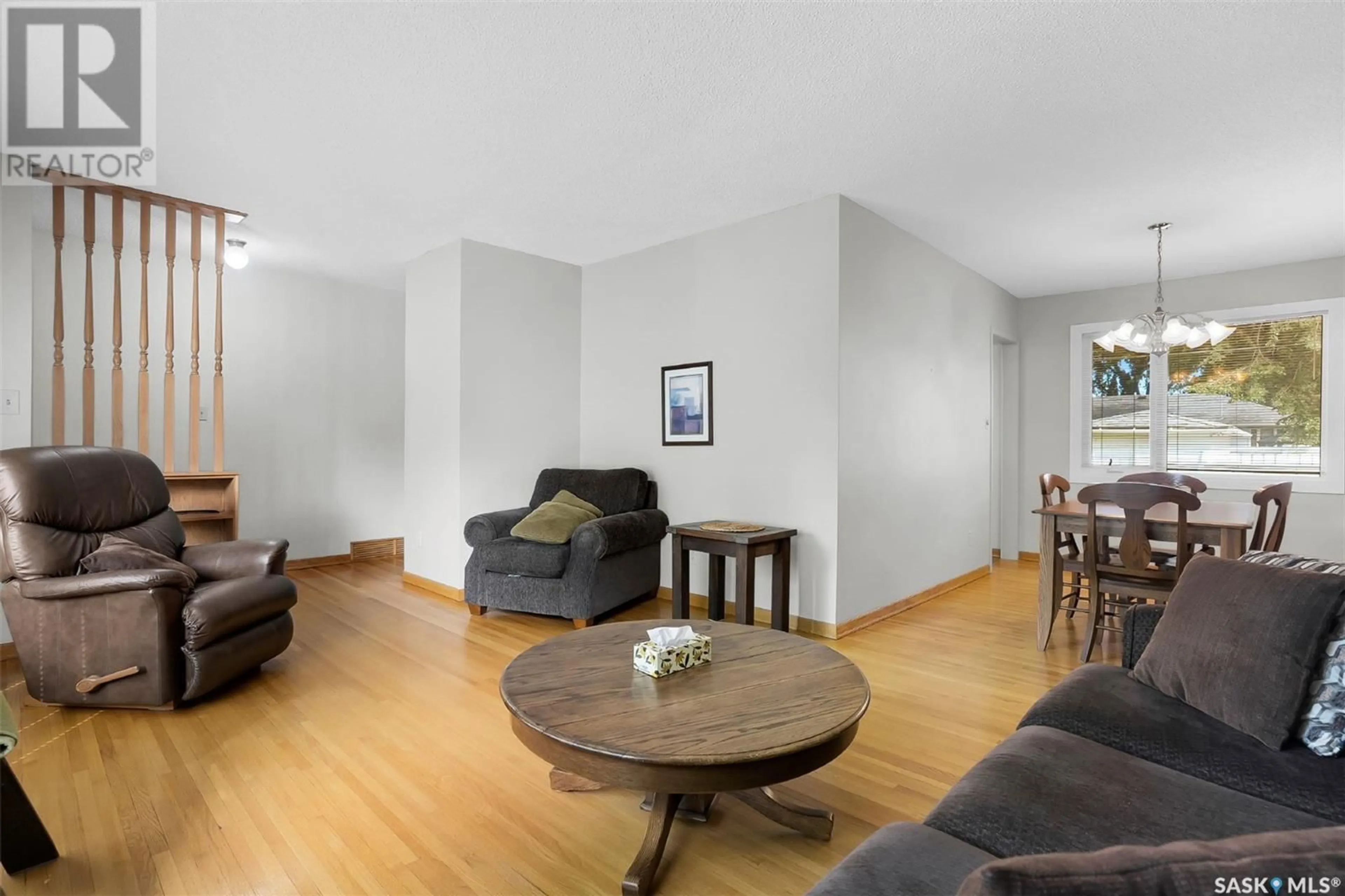 Living room with furniture, wood/laminate floor for 309 CASCADE STREET, Saskatoon Saskatchewan S7J0M4