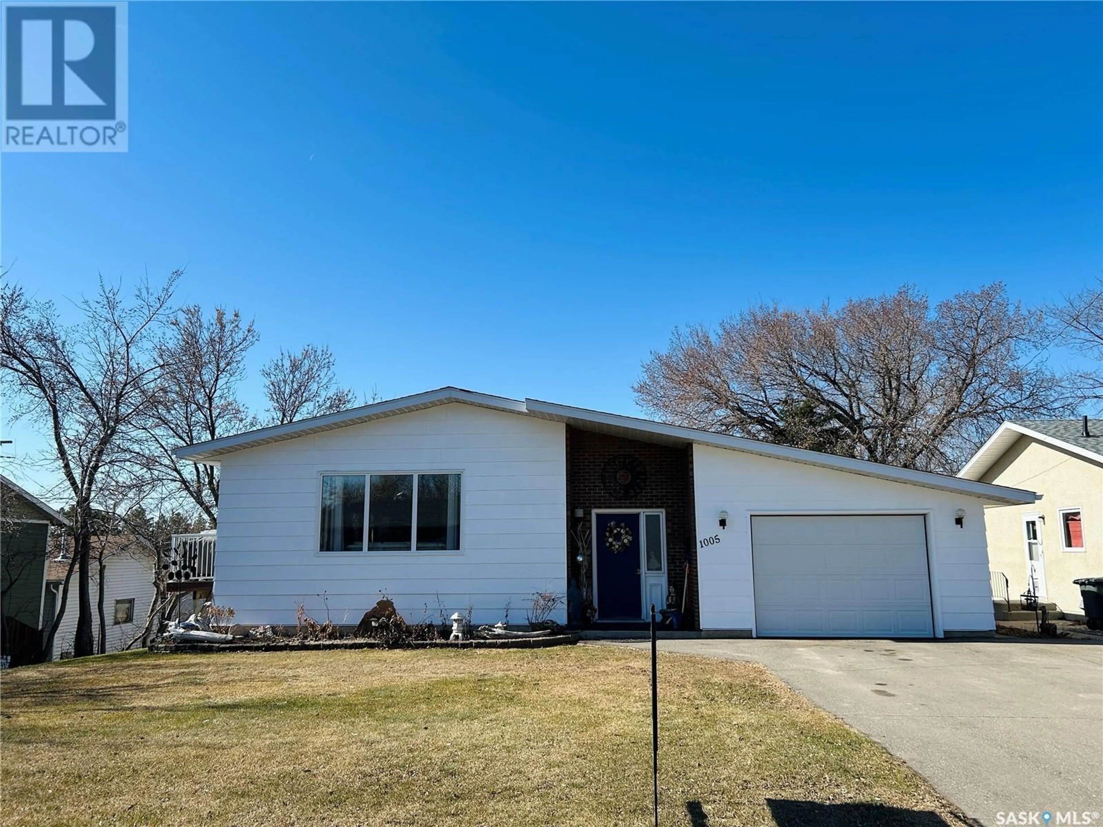 Home with vinyl exterior material, street for 1005 10TH STREET, Rosthern Saskatchewan S0K3R0