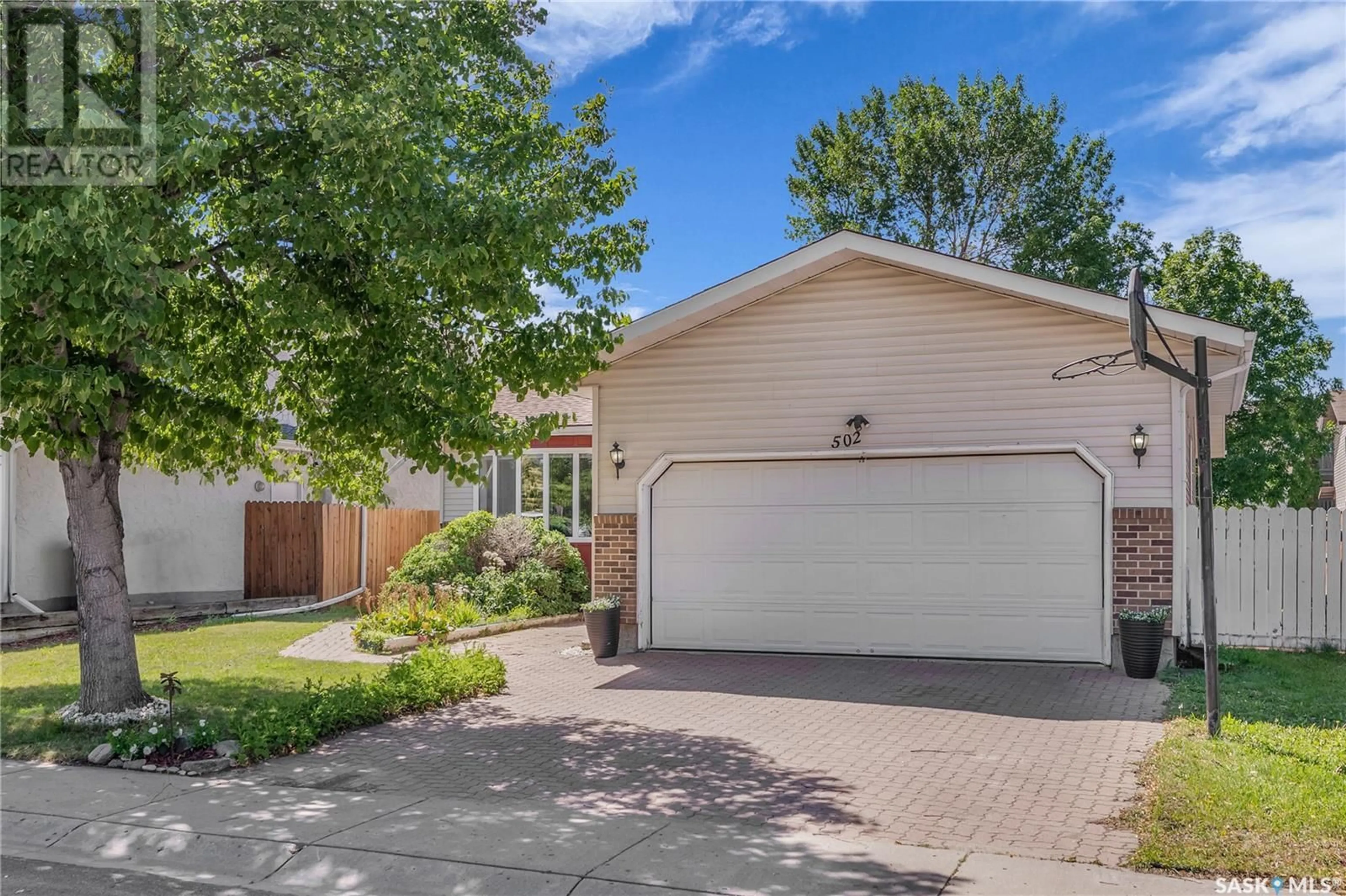 Home with vinyl exterior material, street for 502 BRIGHTSAND CRESCENT, Saskatoon Saskatchewan S7J4Y3