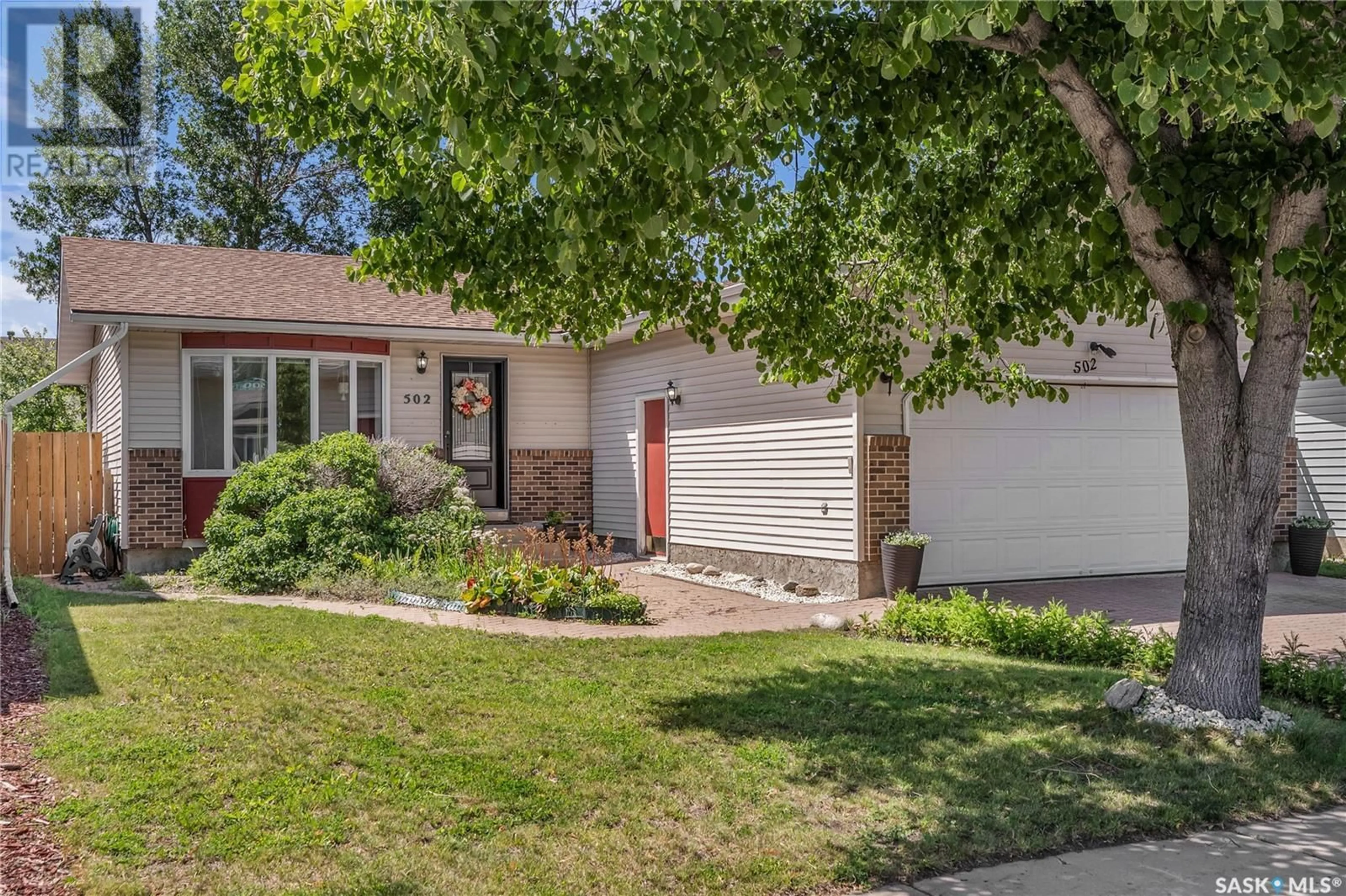 Home with brick exterior material, street for 502 BRIGHTSAND CRESCENT, Saskatoon Saskatchewan S7J4Y3