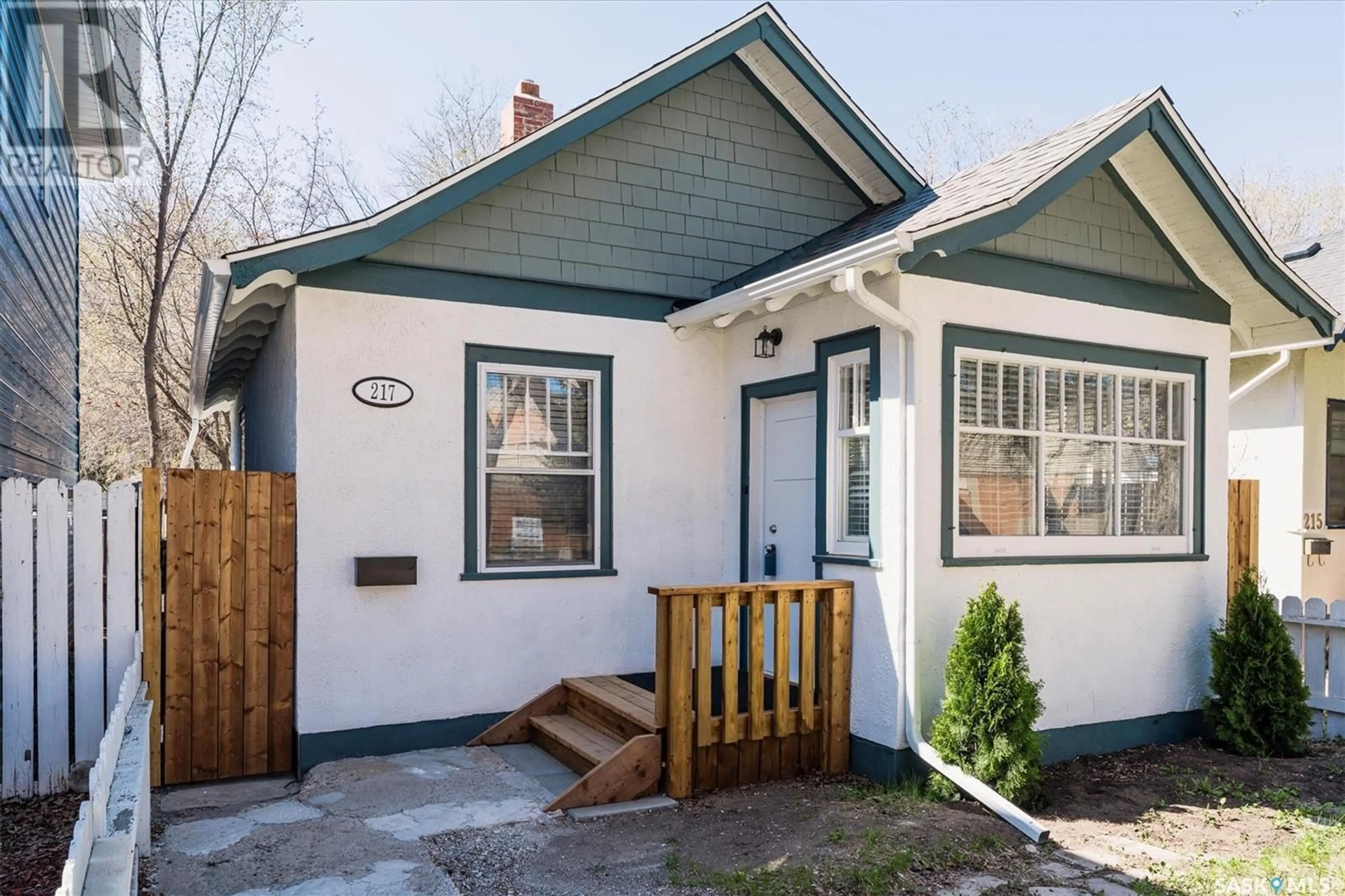Home with vinyl exterior material, street for 217 R AVENUE S, Saskatoon Saskatchewan S7M2Y9