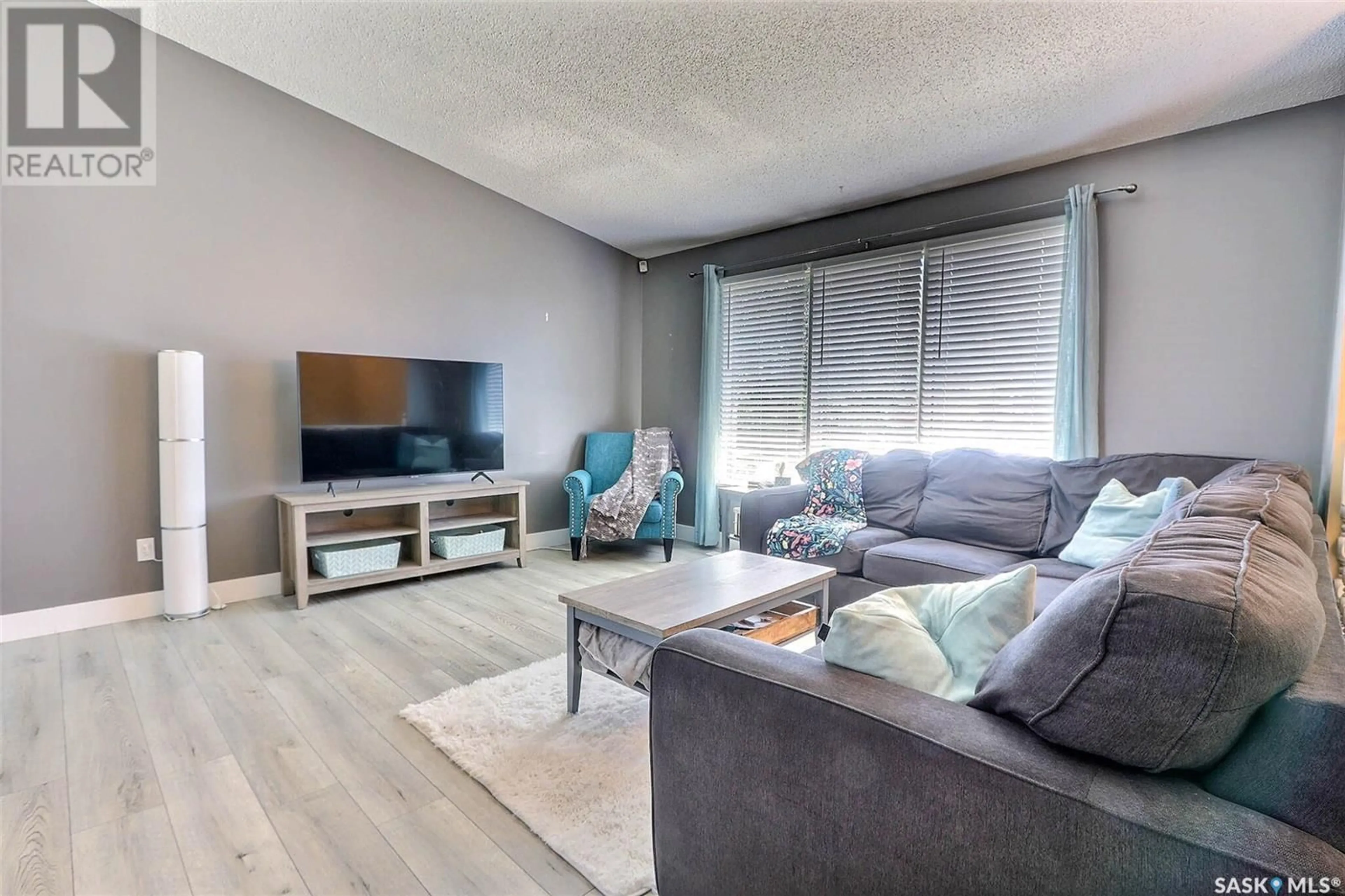 Living room with furniture, wood/laminate floor for 1652 BARTON DRIVE, Prince Albert Saskatchewan S6V7T1