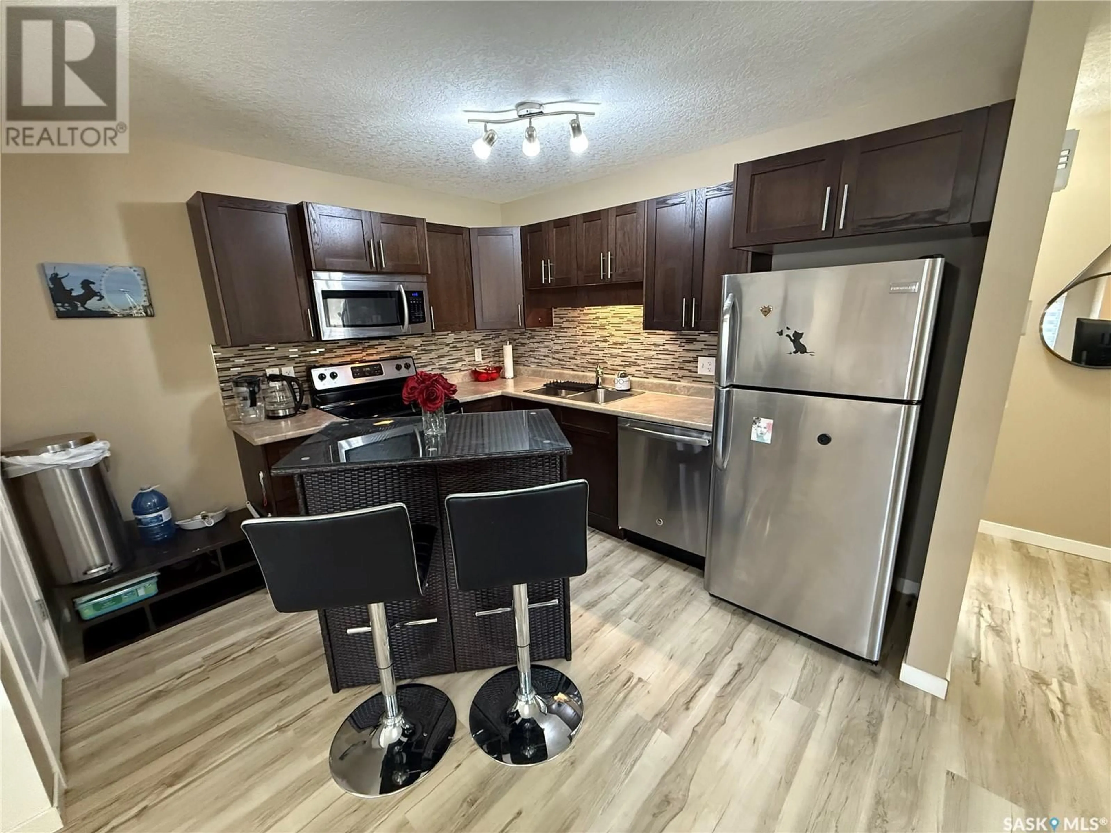 Open concept kitchen, wood/laminate floor for 42 - 5541 BLAKE CRESCENT, Regina Saskatchewan S4X0J1