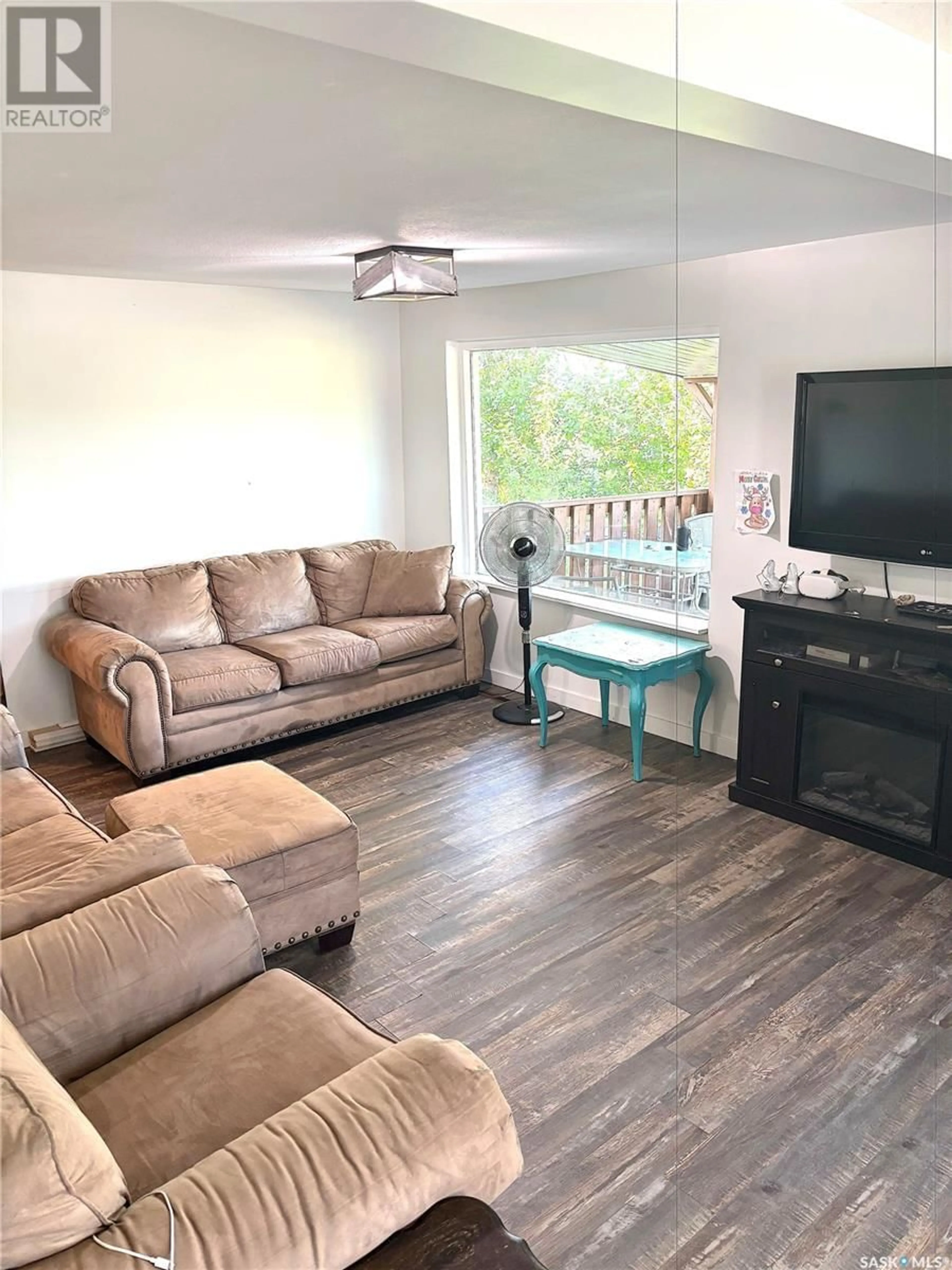 Living room with furniture, wood/laminate floor for KRELLER ACREAGE, Biggar Rm No. 347 Saskatchewan S0K0M0