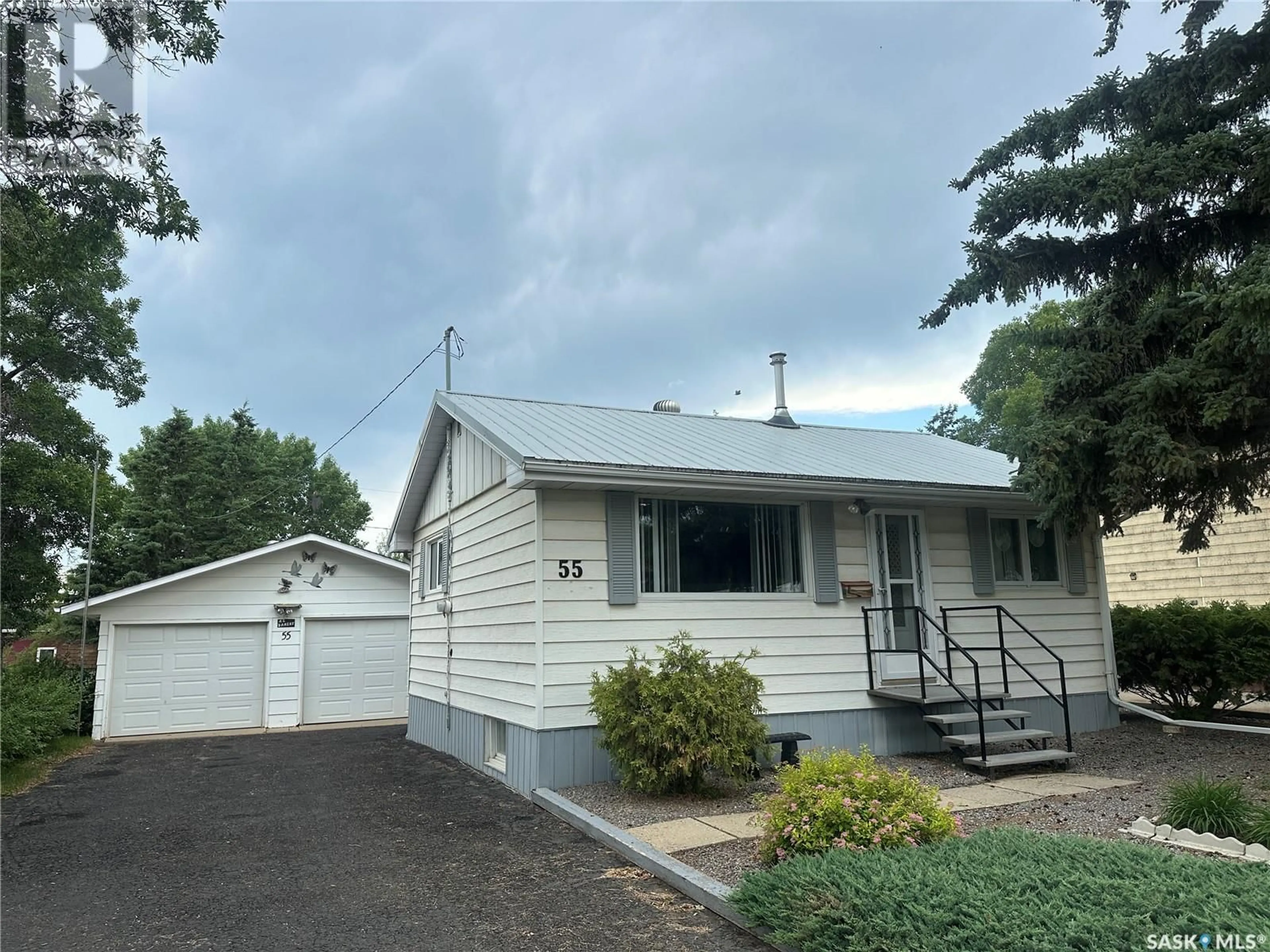 Home with vinyl exterior material, street for 55 12TH STREET, Weyburn Saskatchewan S4H1K4