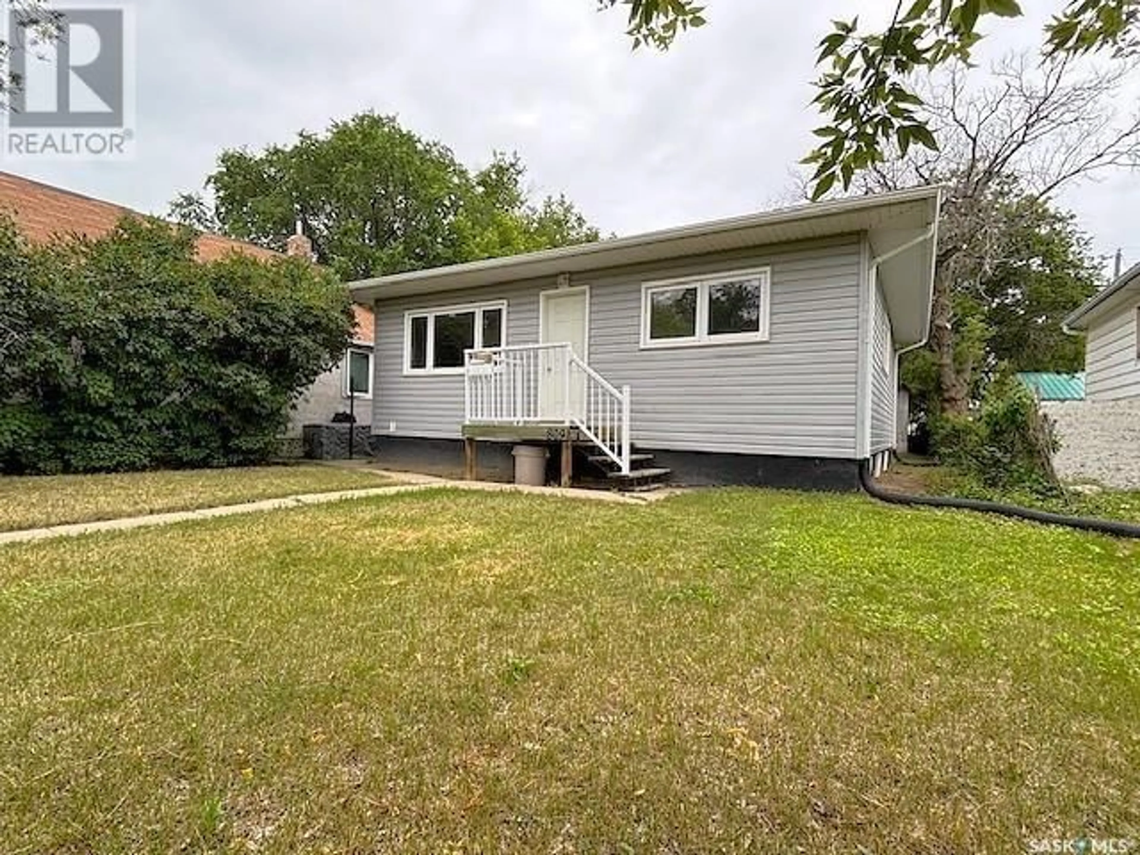 Home with vinyl exterior material, street for 809 CARTIER AVENUE, Moose Jaw Saskatchewan S6H1L9