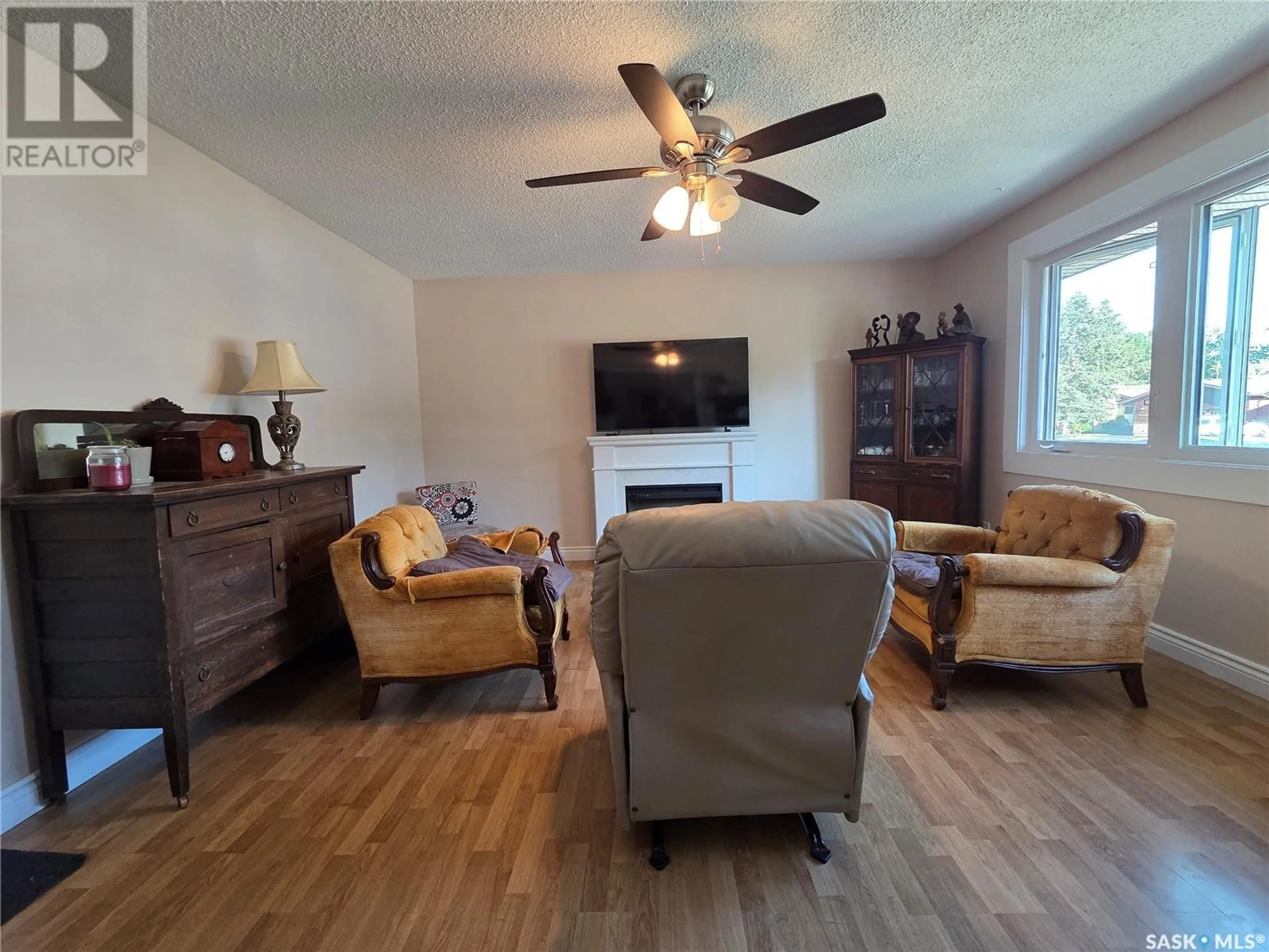 Living room with furniture, wood/laminate floor for 119 SYLVITE CRESCENT, Allan Saskatchewan S0K0C0